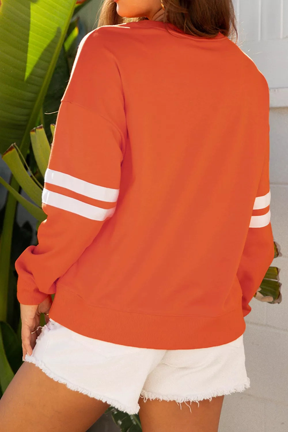 Spooky Season Ghost Striped Sleeve Sweatshirt in orange, back view