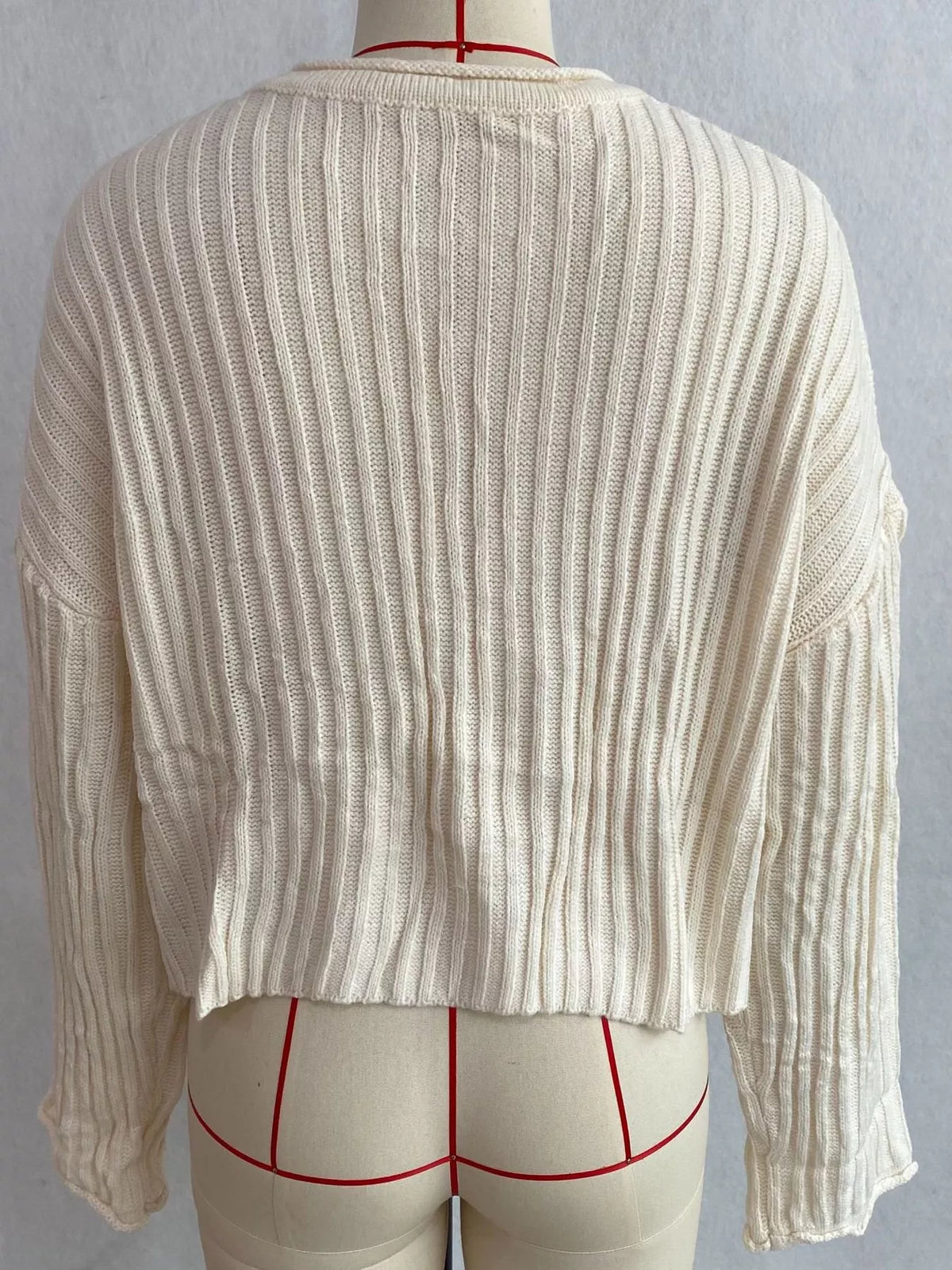 Ivory ribbed lace-up cropped sweater, back on dress form.