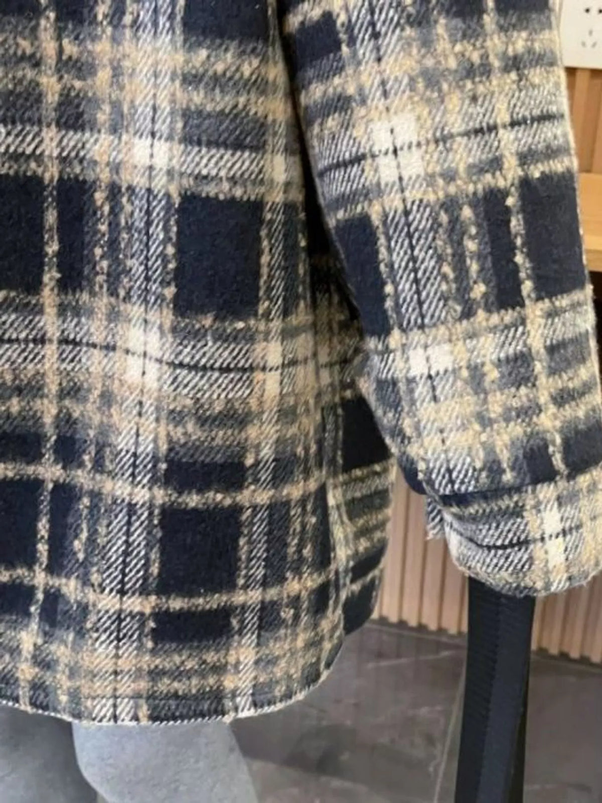Black plaid button-up hooded shacket, plaid sleeve and curved hem