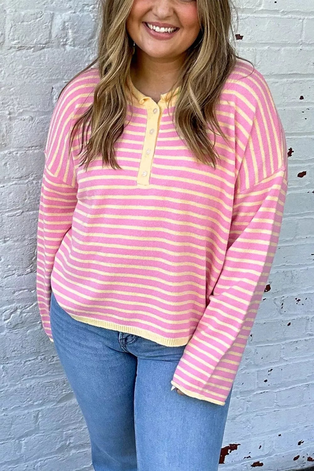 Pink and yellow striped button-detail sweater, front view