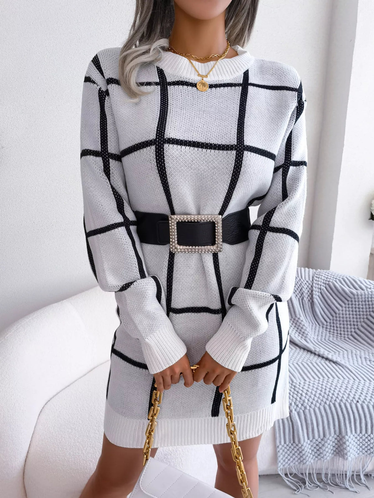 White windowpane long-sleeve sweater dress, belted front with handbag.