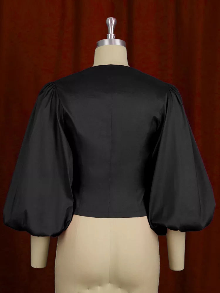 Black double-breasted puff sleeve blouse, back view