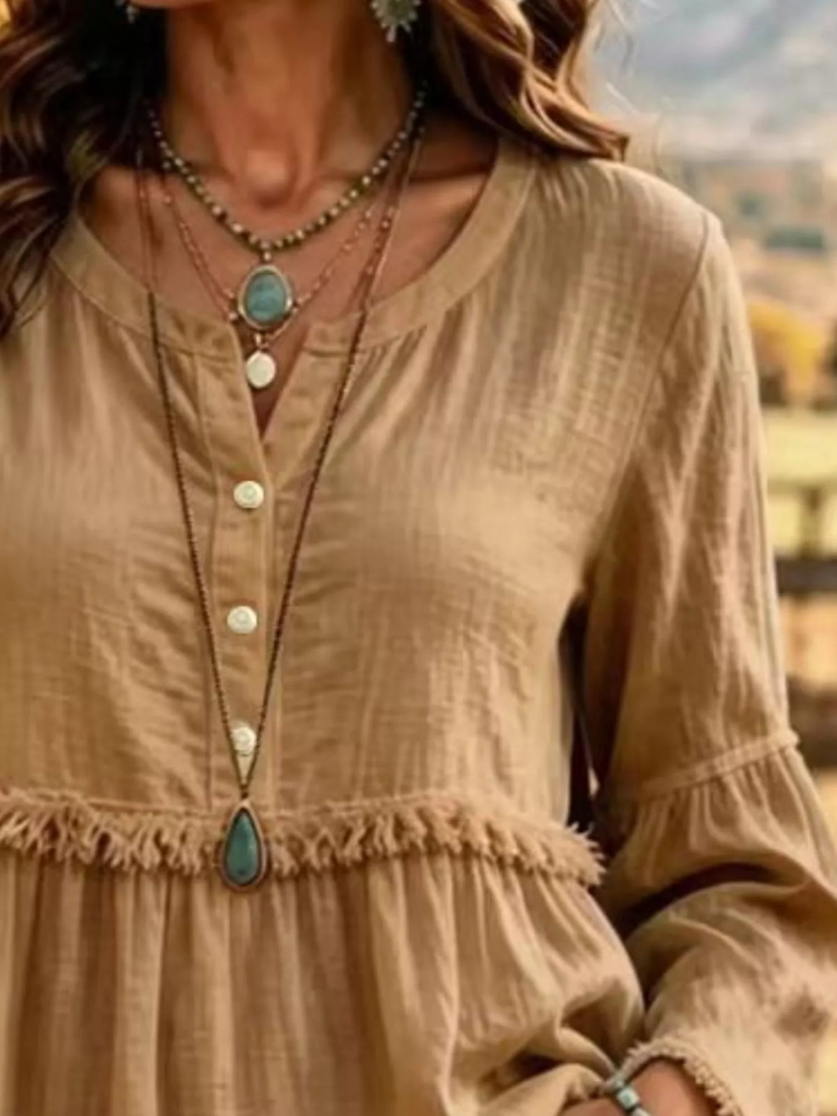 Camel fringed button detail blouse, split neckline, front buttons, and frayed waist seam