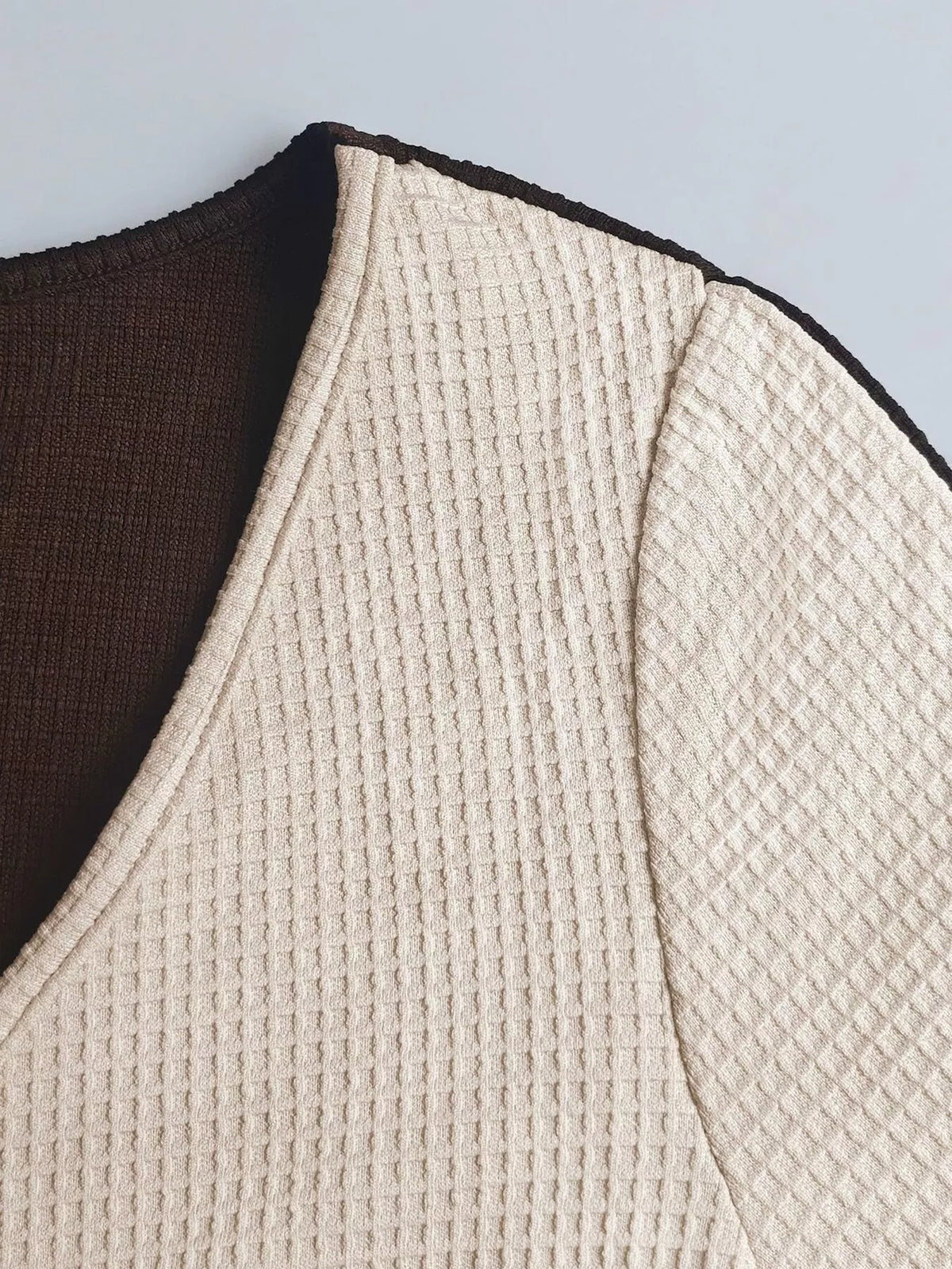 Brown and cream two-tone top and skirt set, close-up of neckline and shoulder