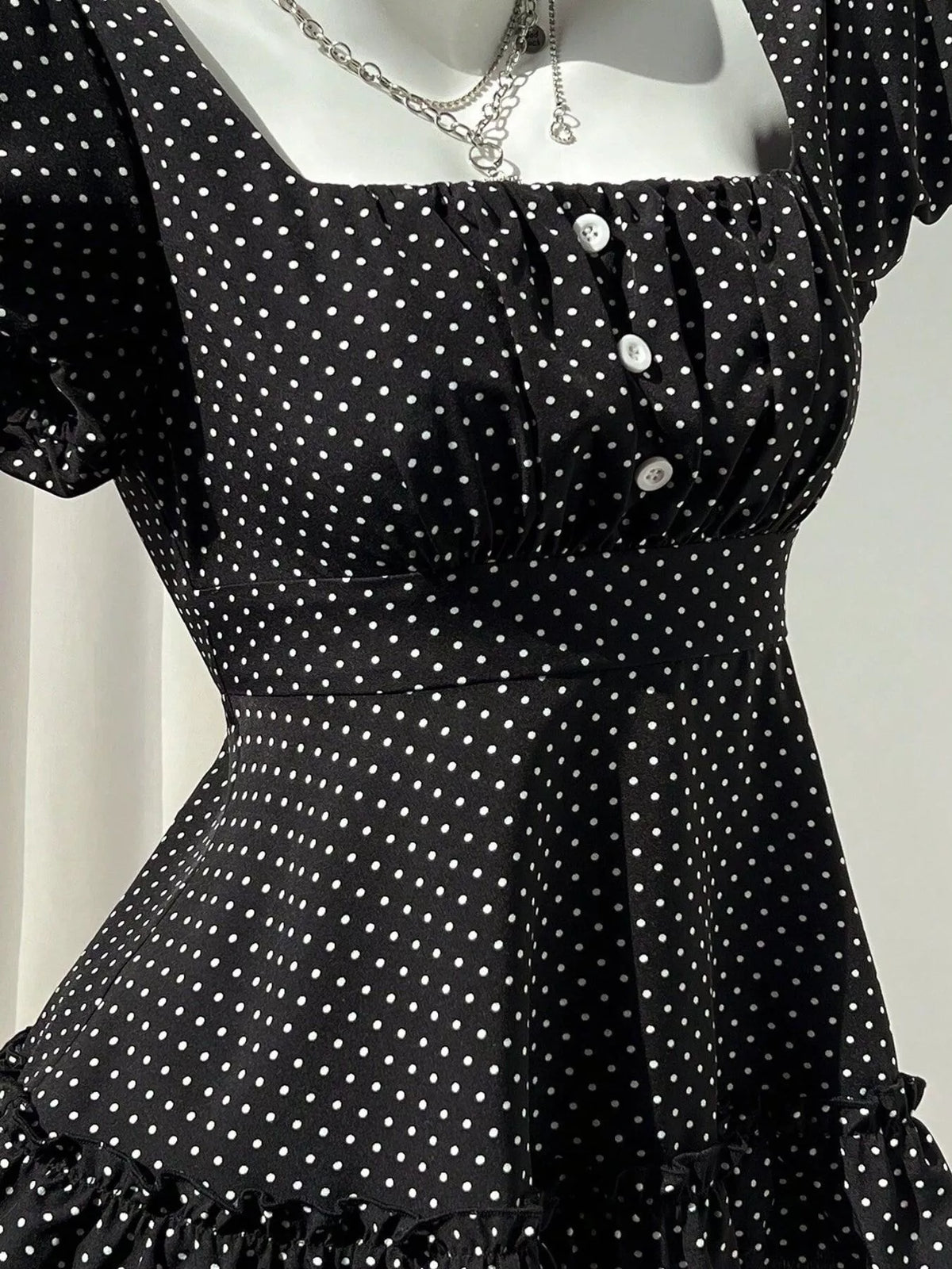 Polka-dot peplum blouse, black button detail