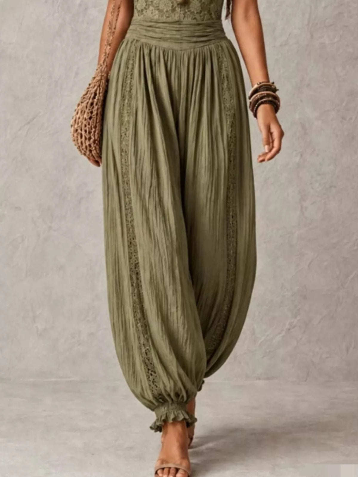Olive lace-bodice harem-leg jumpsuit, harem pants detail.