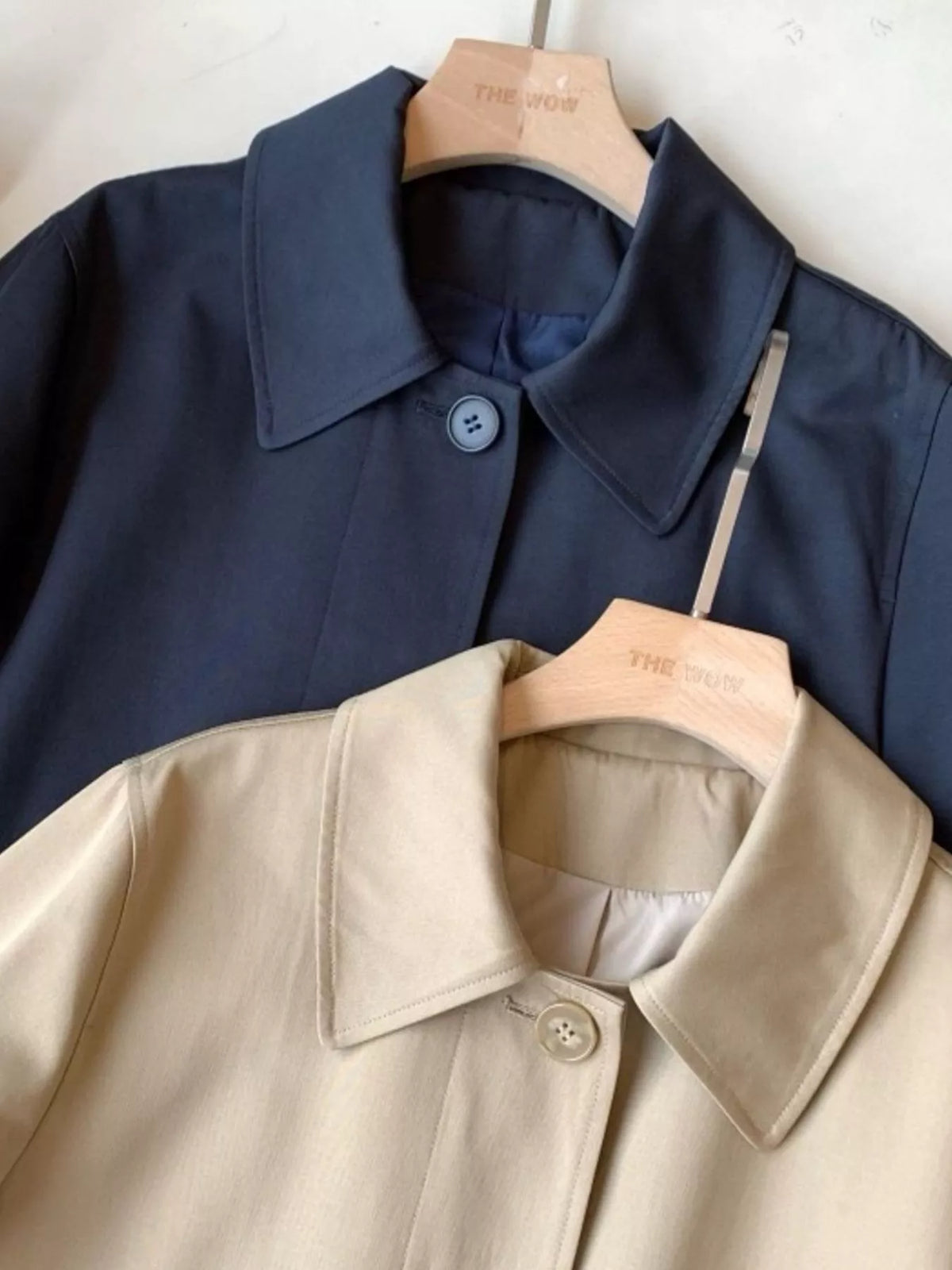 Beige and navy single-breasted trench coat, collar and button-front comparison