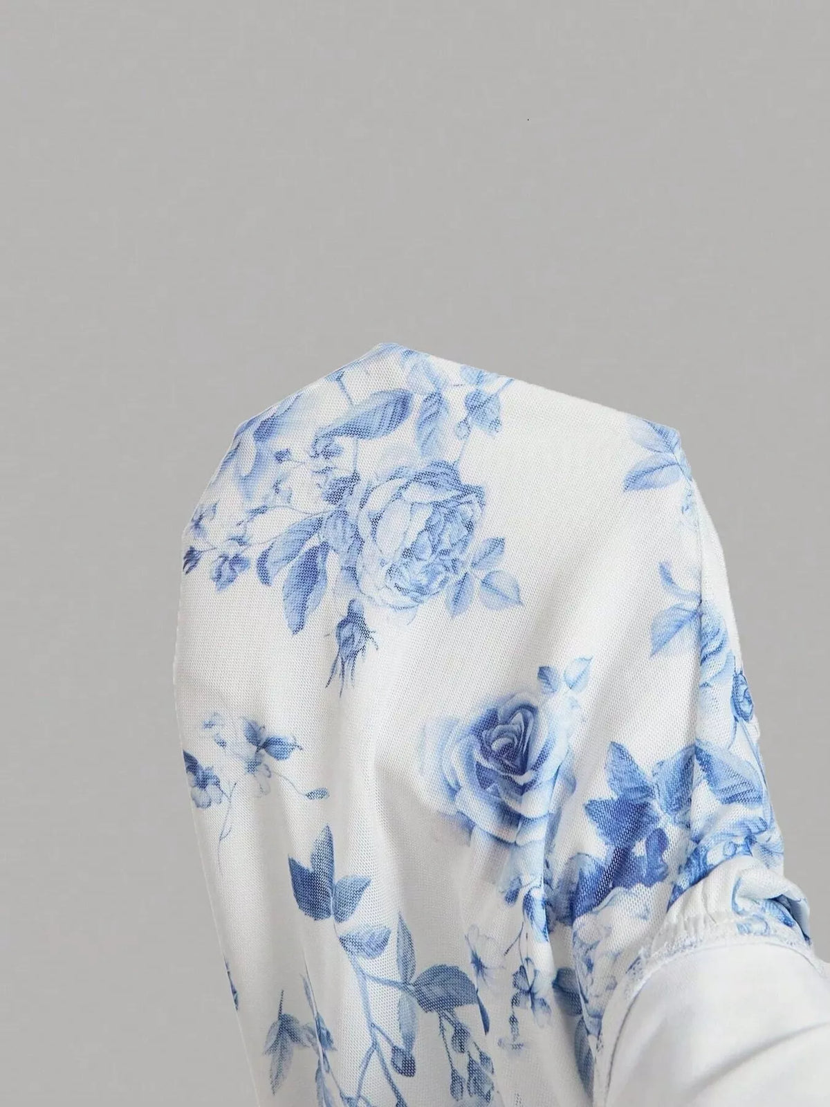Blue and white floral bodycon midi dress, bodice detail.