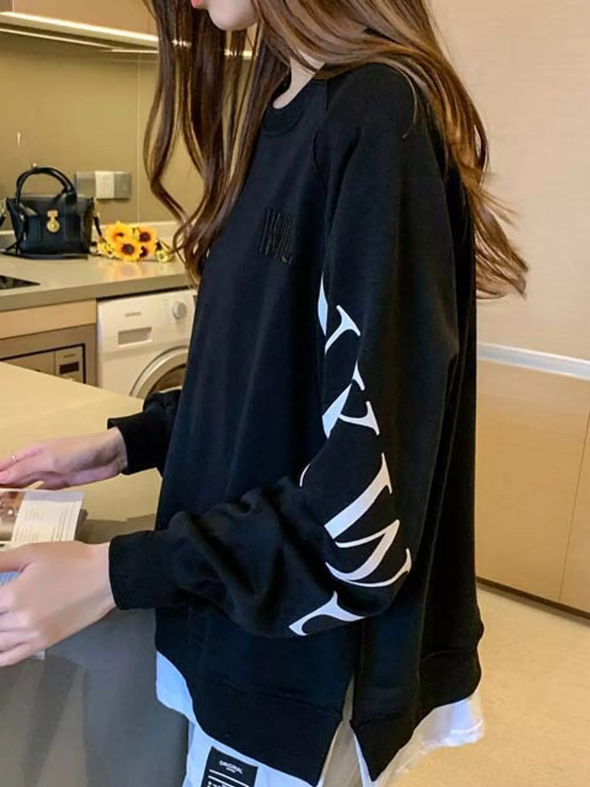 Layered-hem sweatshirt with graphic sleeve detail, back view