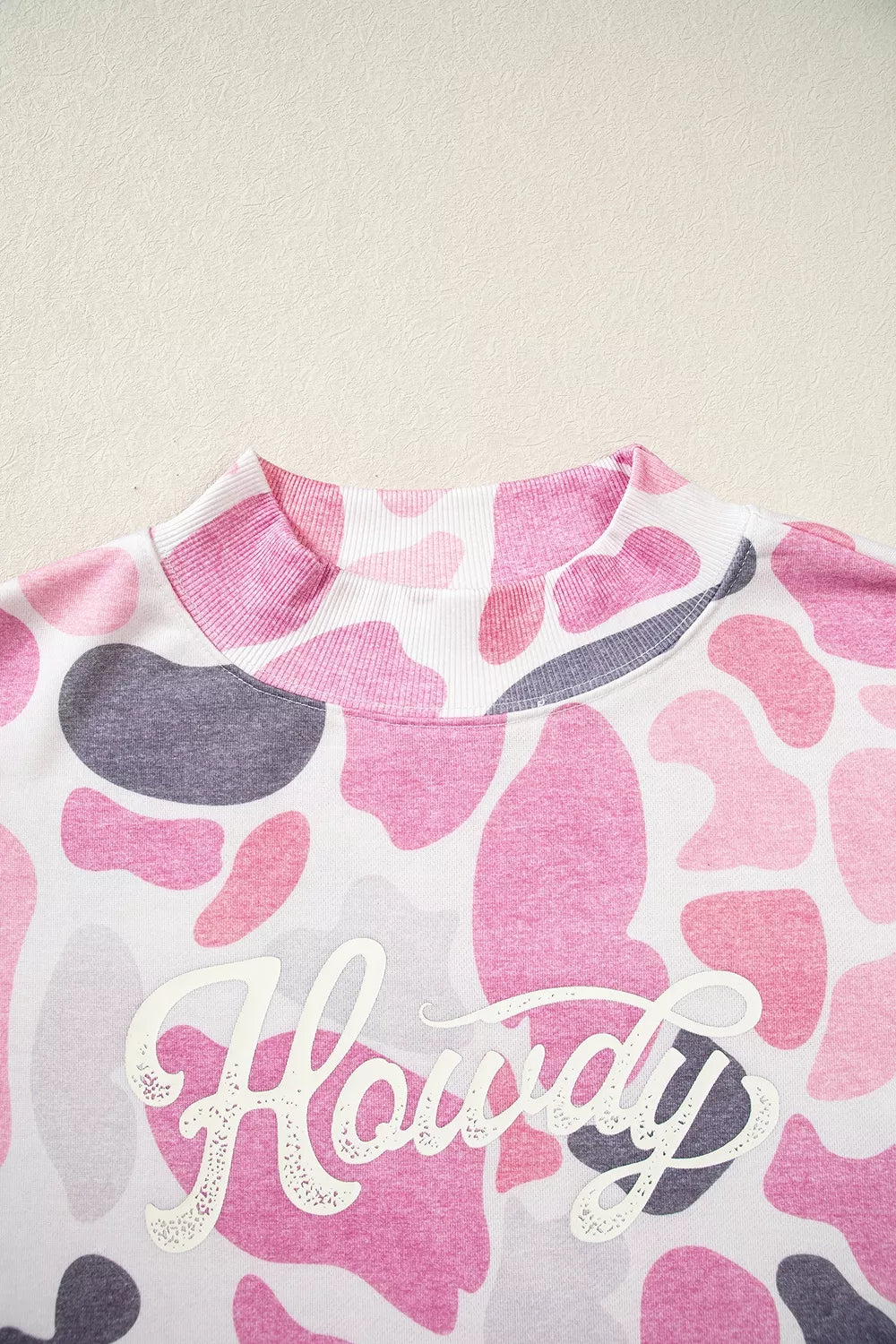 Pink camouflage Howdy sweatshirt, neckline and Howdy graphic