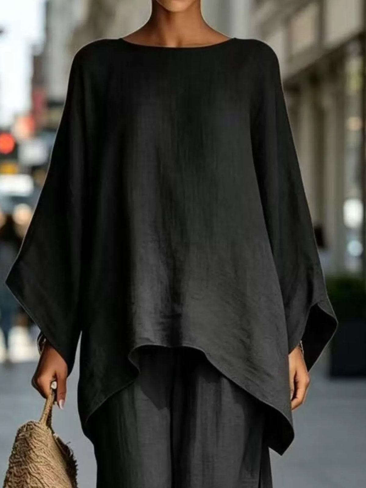 Black batwing top, neckline and hem view
