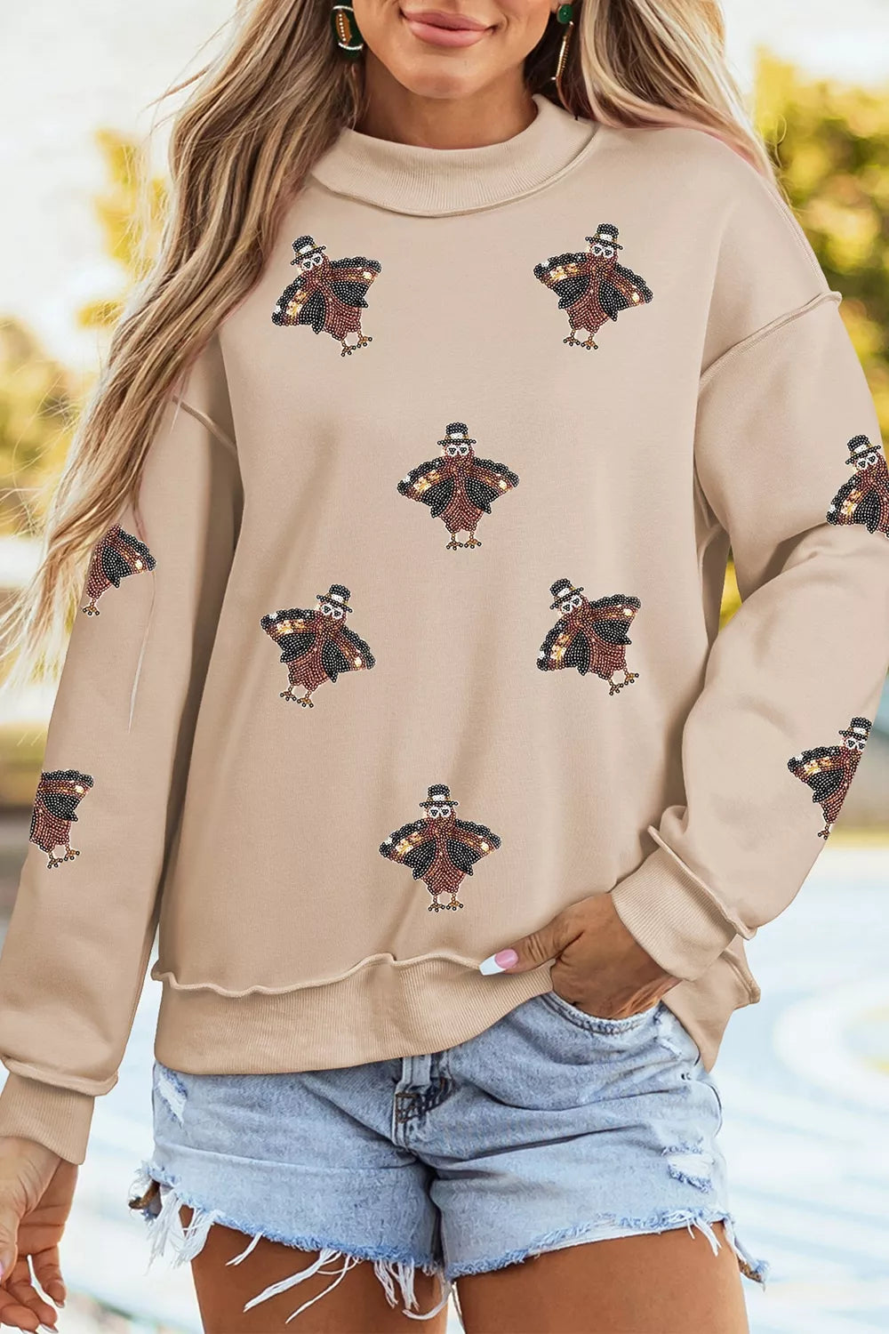Sequin turkey mock-neck exposed-seam sweatshirt