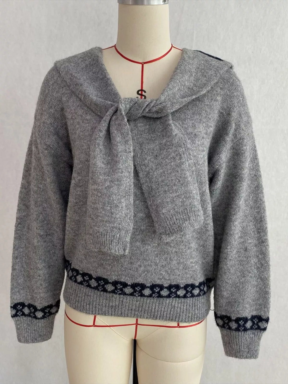 Gray scarf-detail dropped-shoulder sweater, front on dress form.
