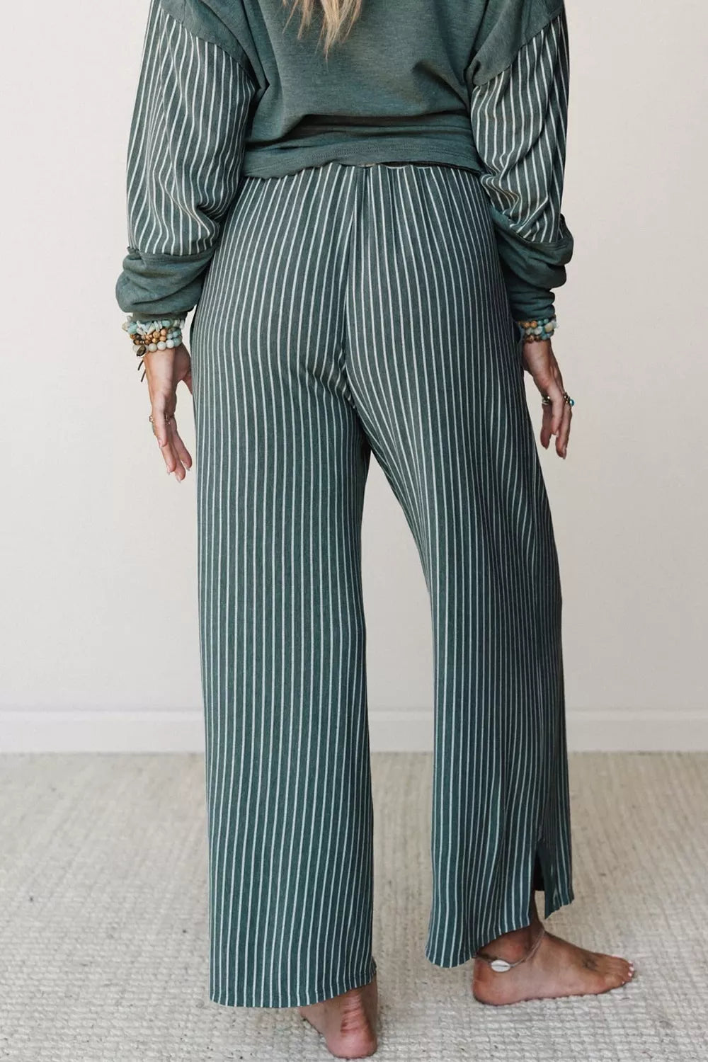 Green raw-seam top and striped pants set, back of pants