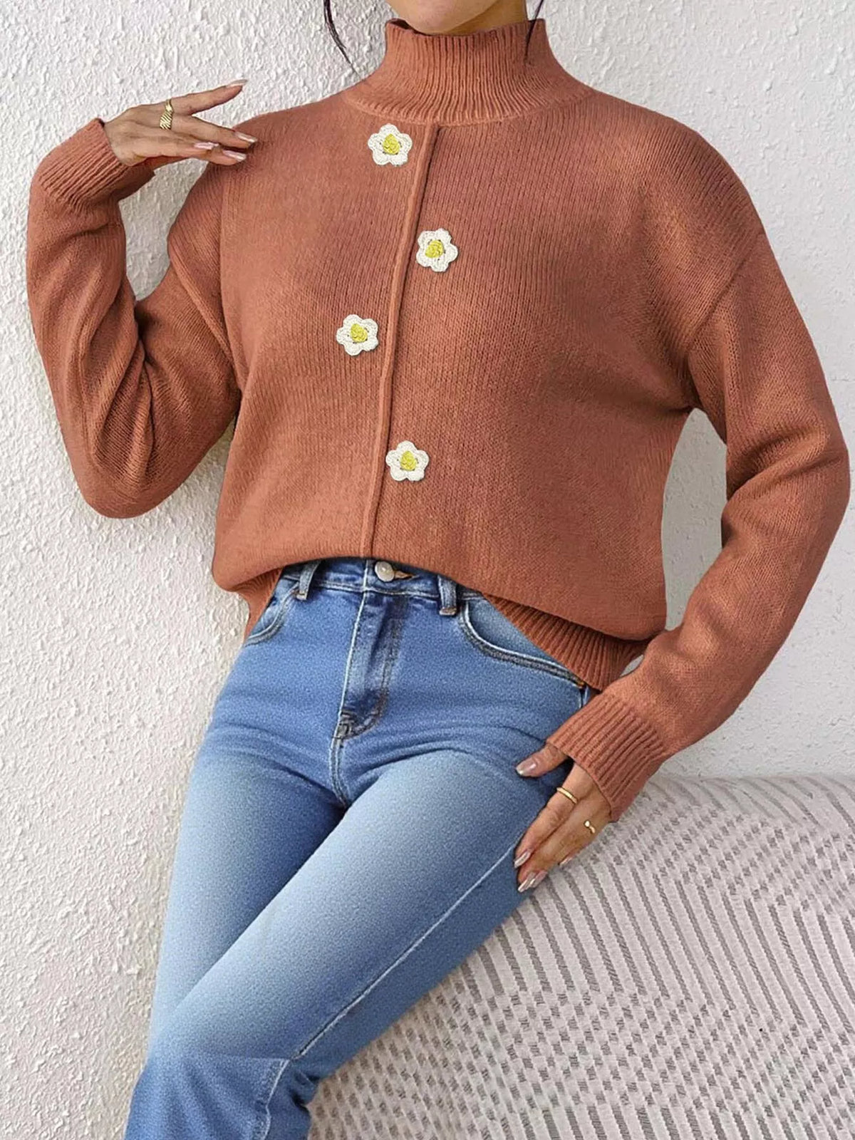 Rust floral applique mock-neck sweater, seated front view.