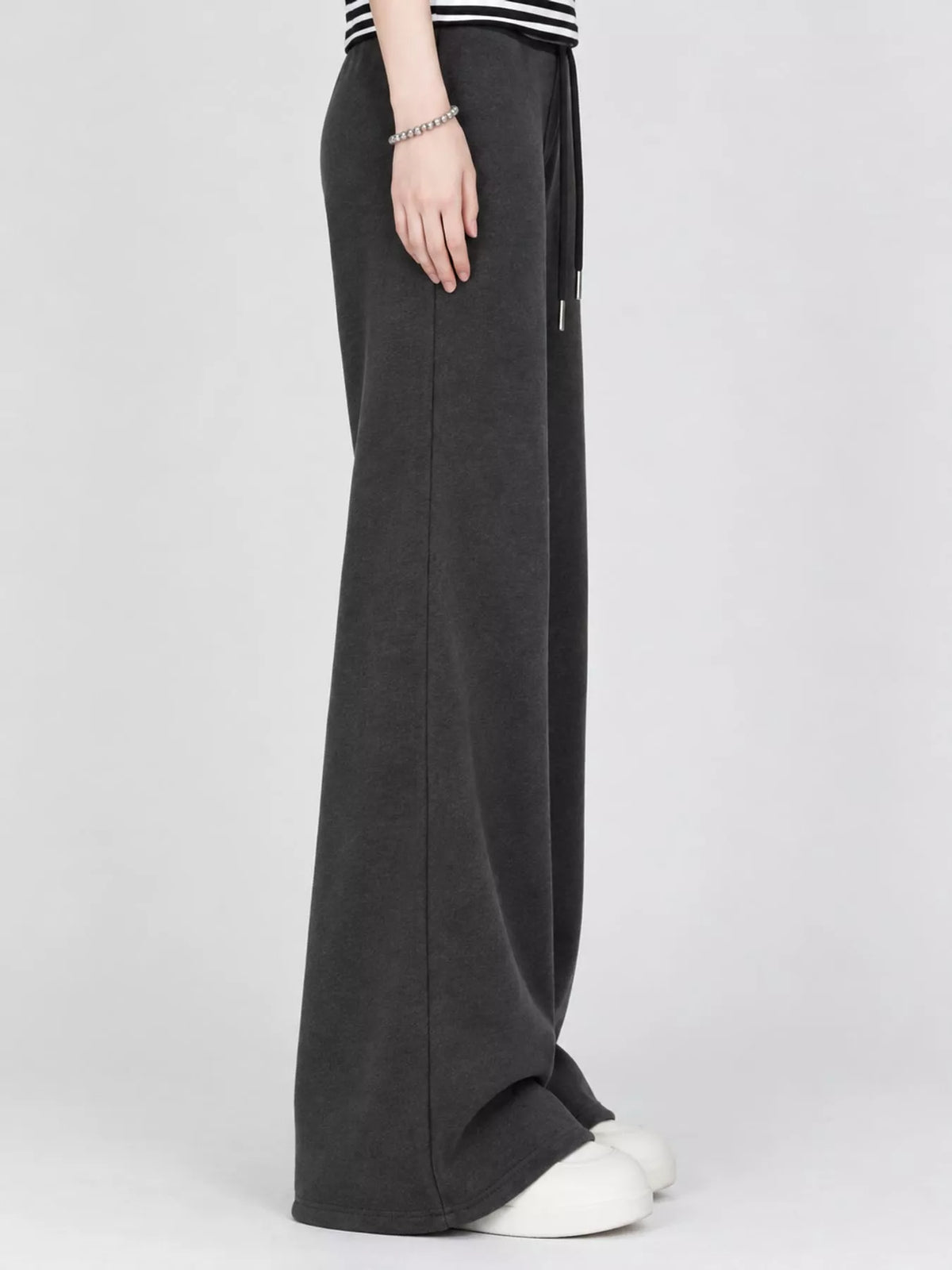 Black drawstring pants, side view