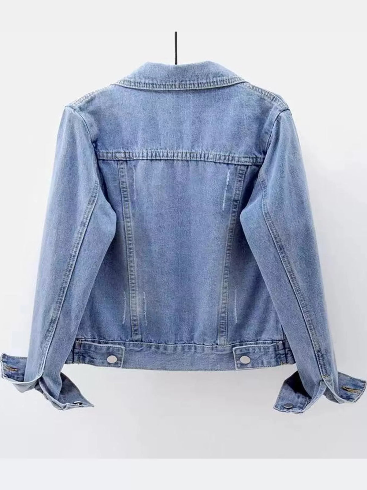 Light blue button-down front denim jacket, back view