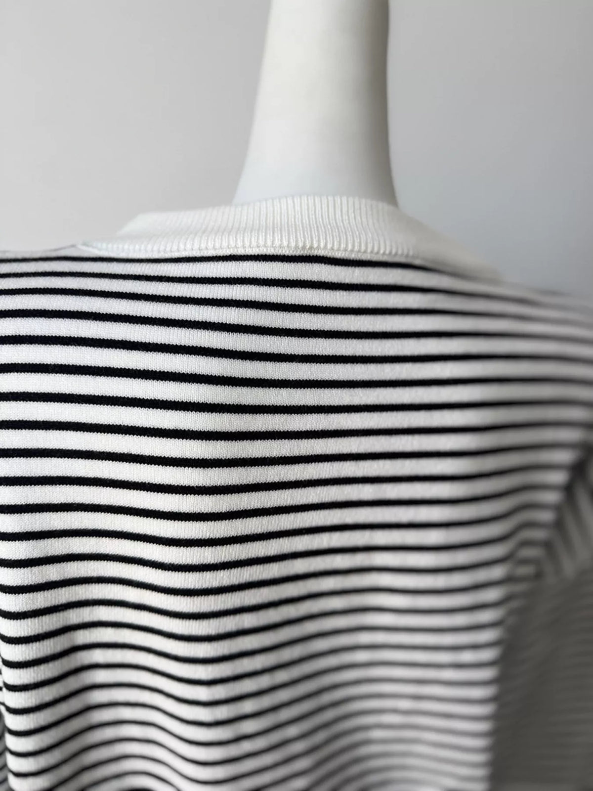 Striped round-neck knit top in white and black, back neckline detail