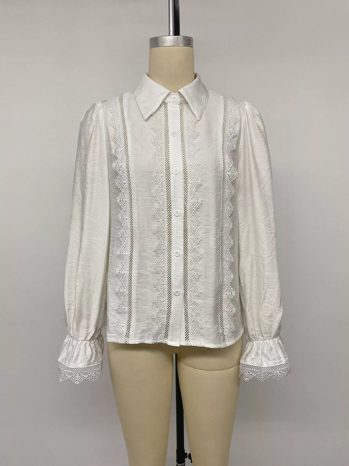 White lace-trimmed button-down shirt, front on mannequin