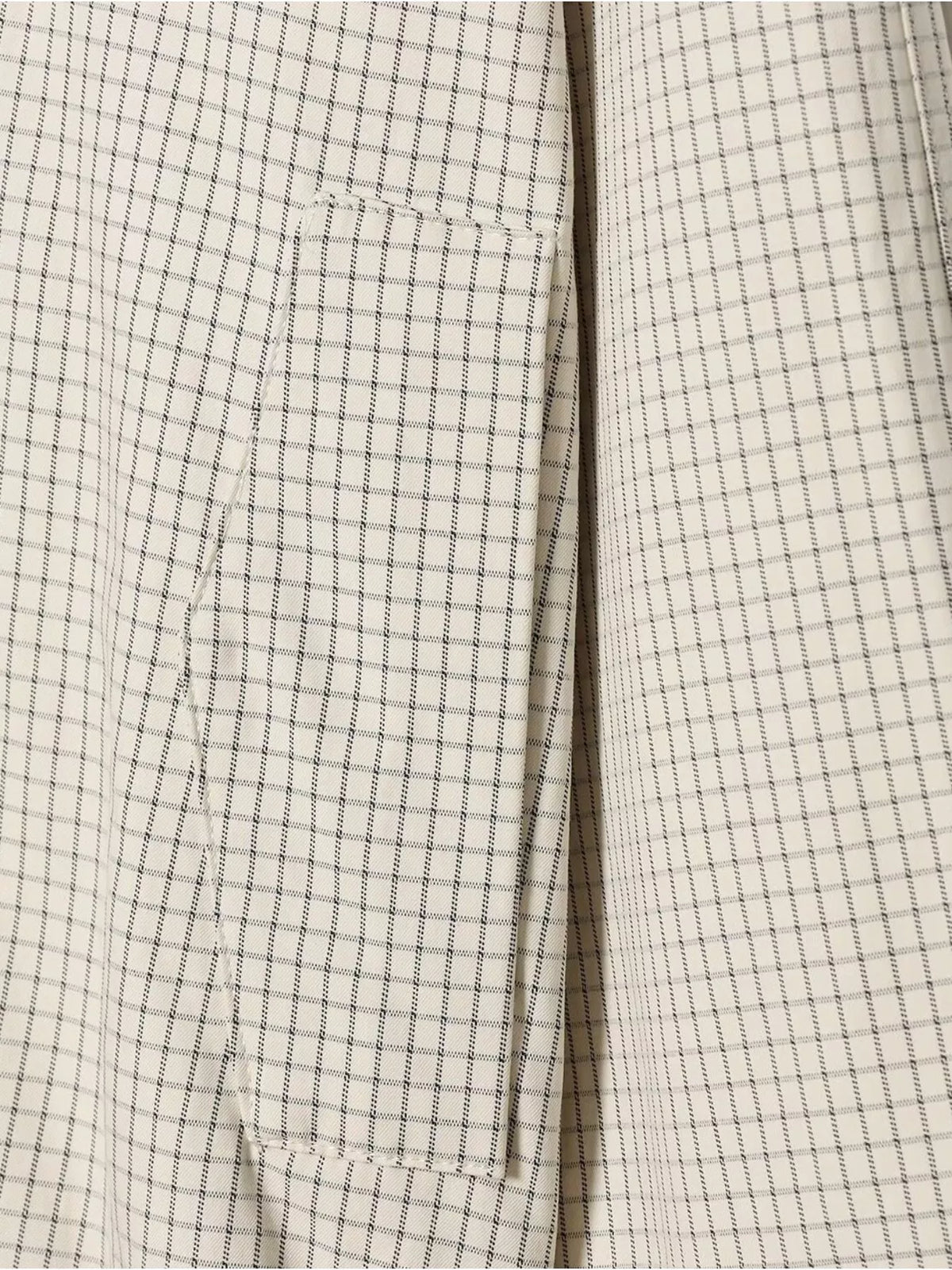 Front seam and pocket on cream check plaid double-breasted cropped jacket