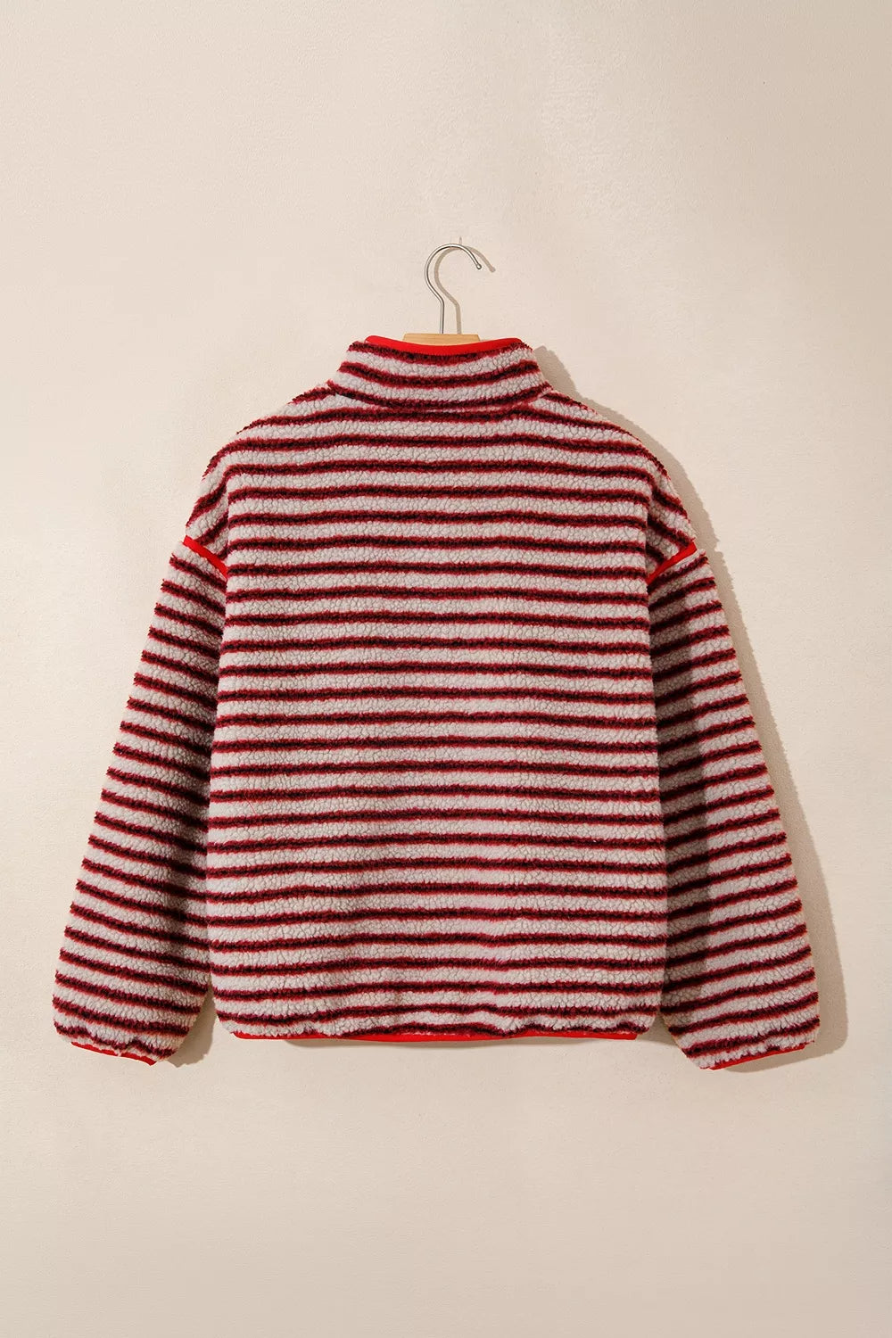 Red and cream striped fuzzy snap-placket sweatshirt, back on hanger