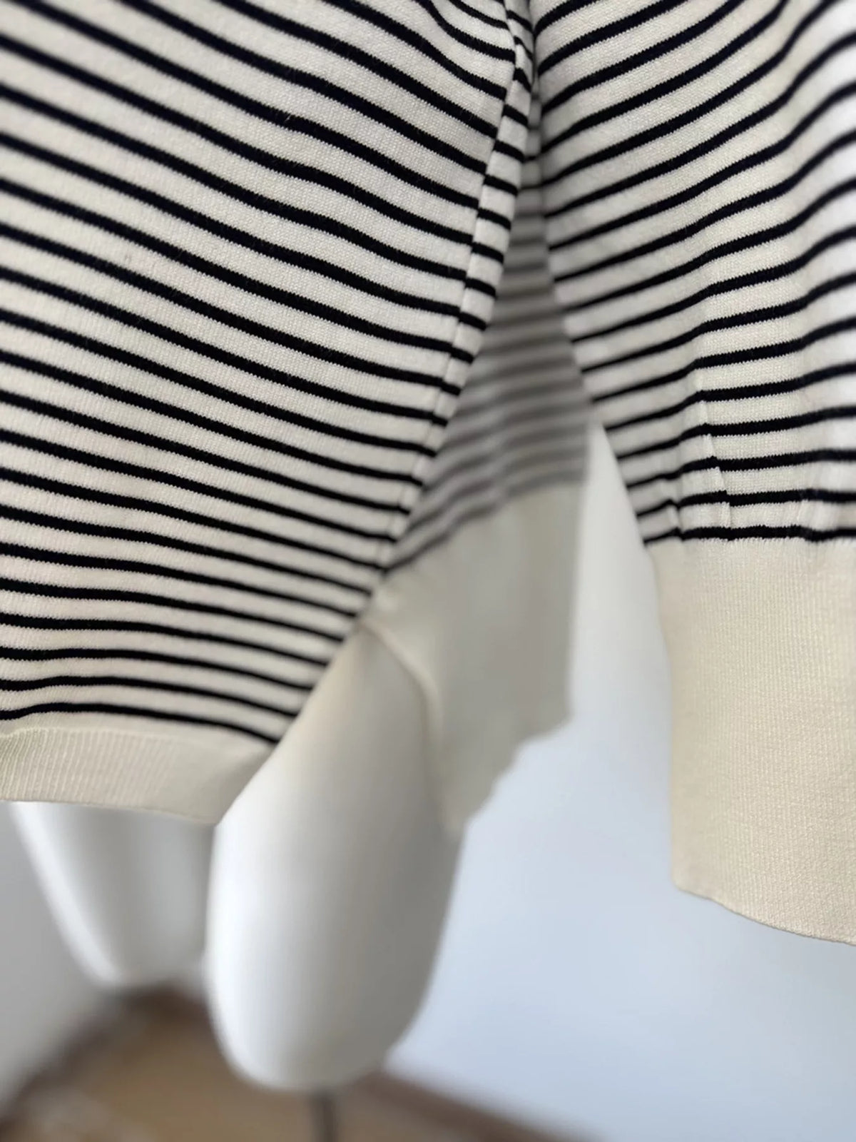 Striped round-neck knit top in white and black, side slit detail