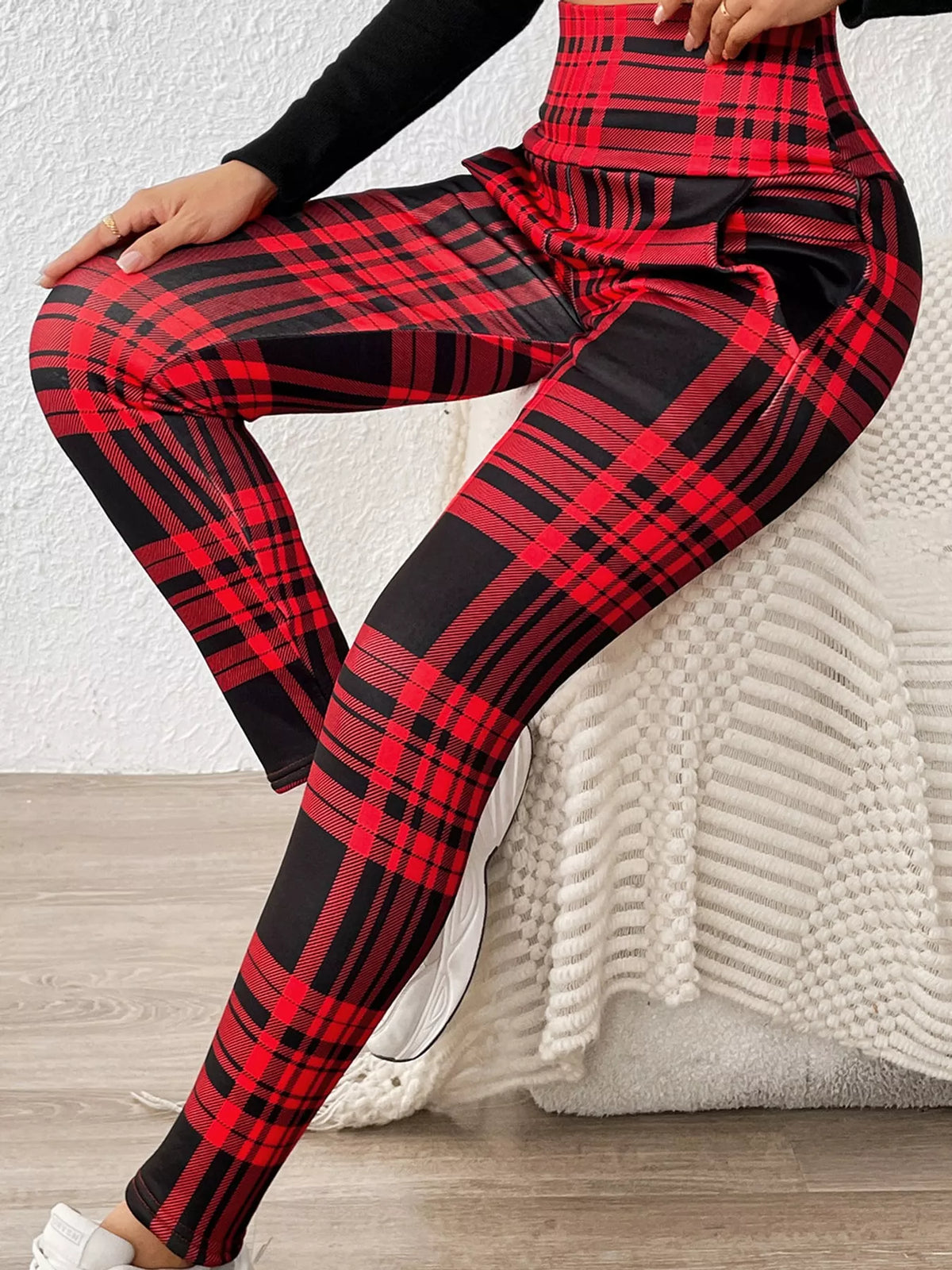 Plaid leggings, red and black seated view