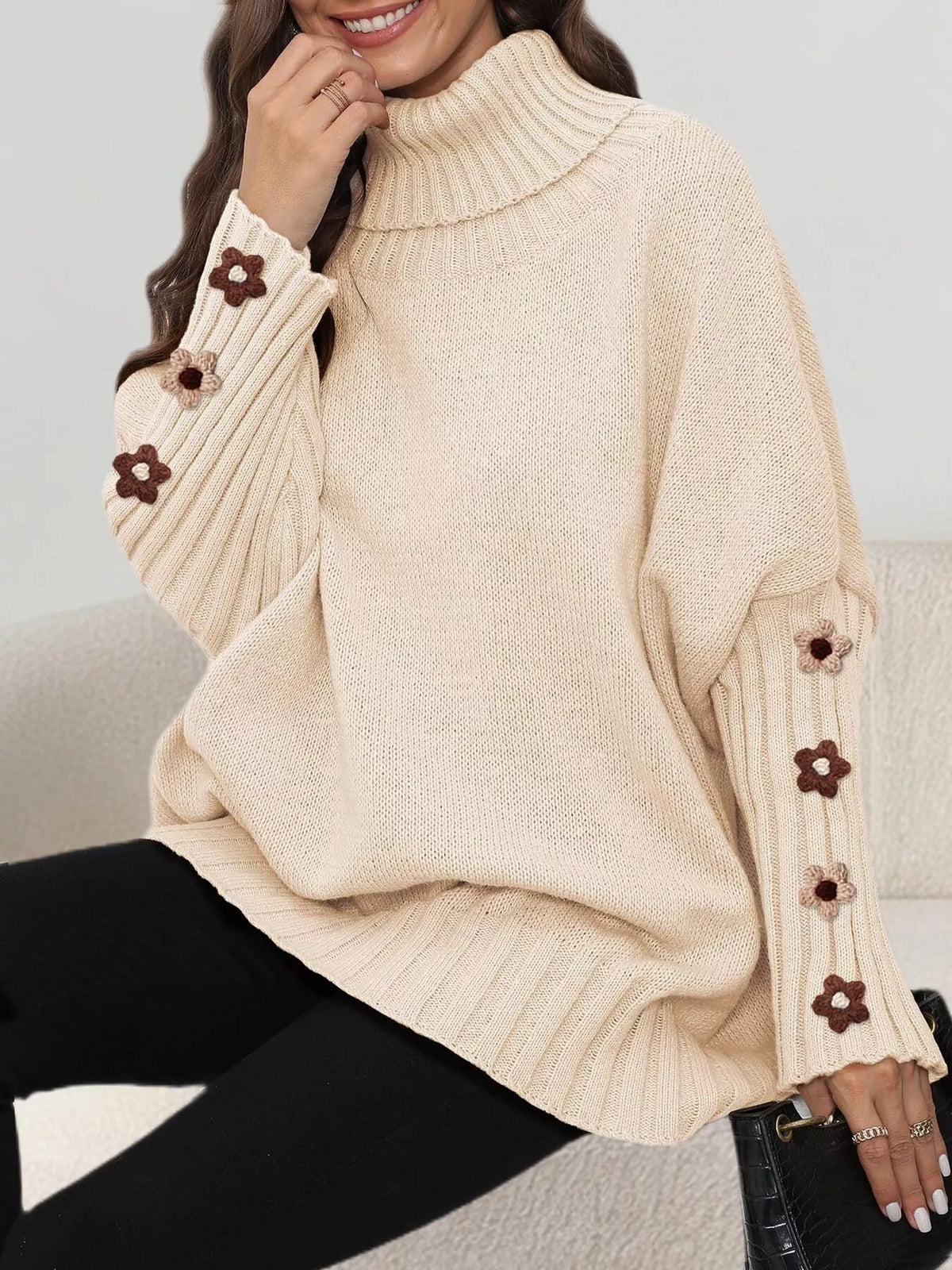 Beige oversized floral sleeve turtleneck sweater, seated view