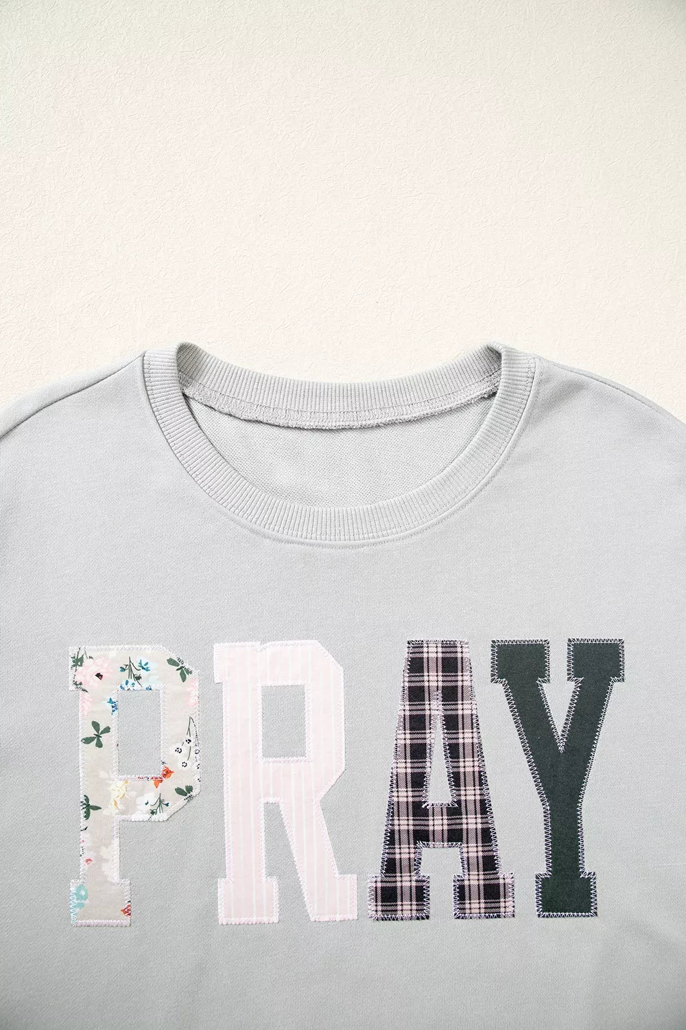 Gray floral and plaid PRAY patch sweatshirt, PRAY lettering and neckline