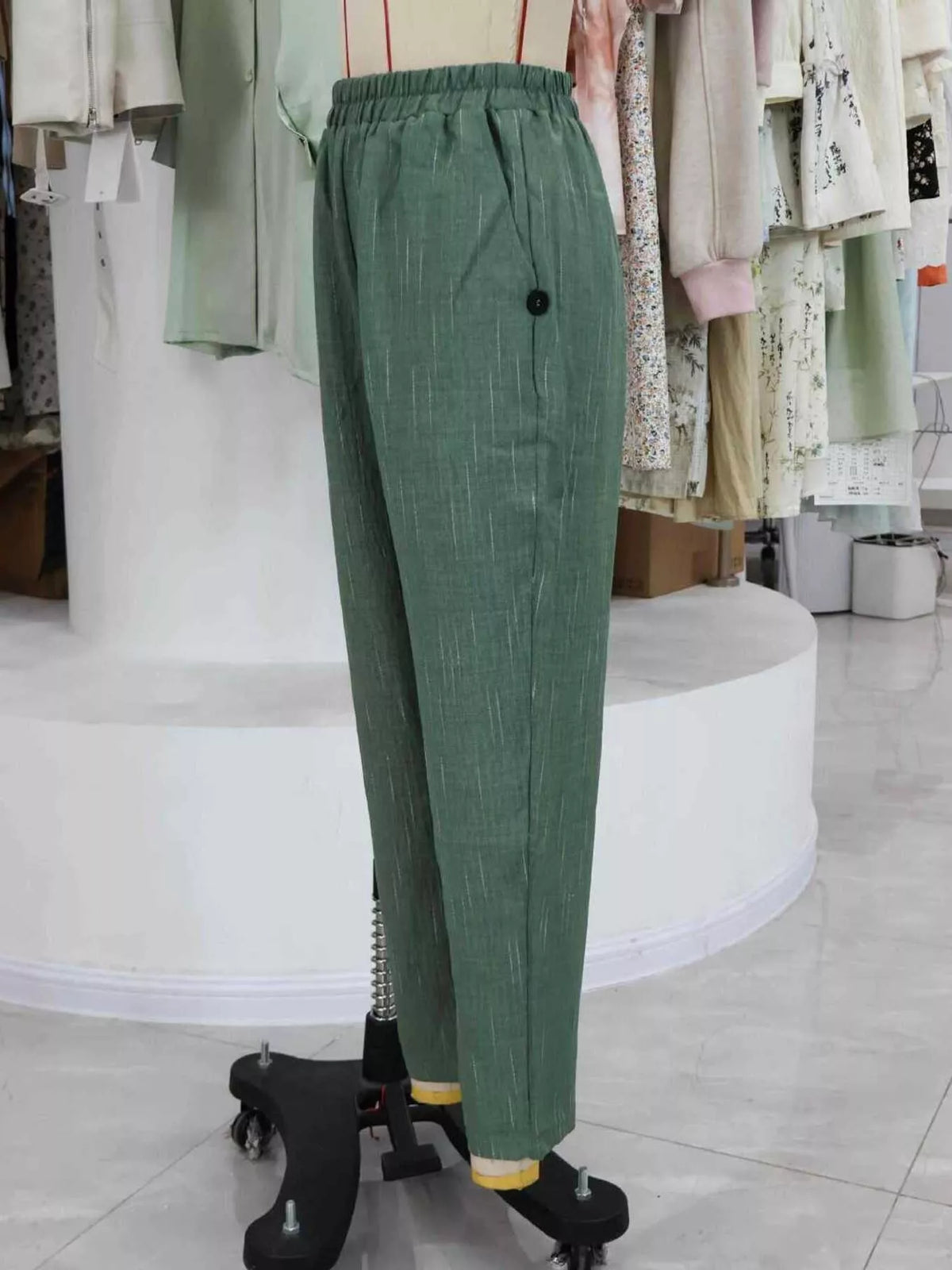 Green loose fit cropped pants, side view