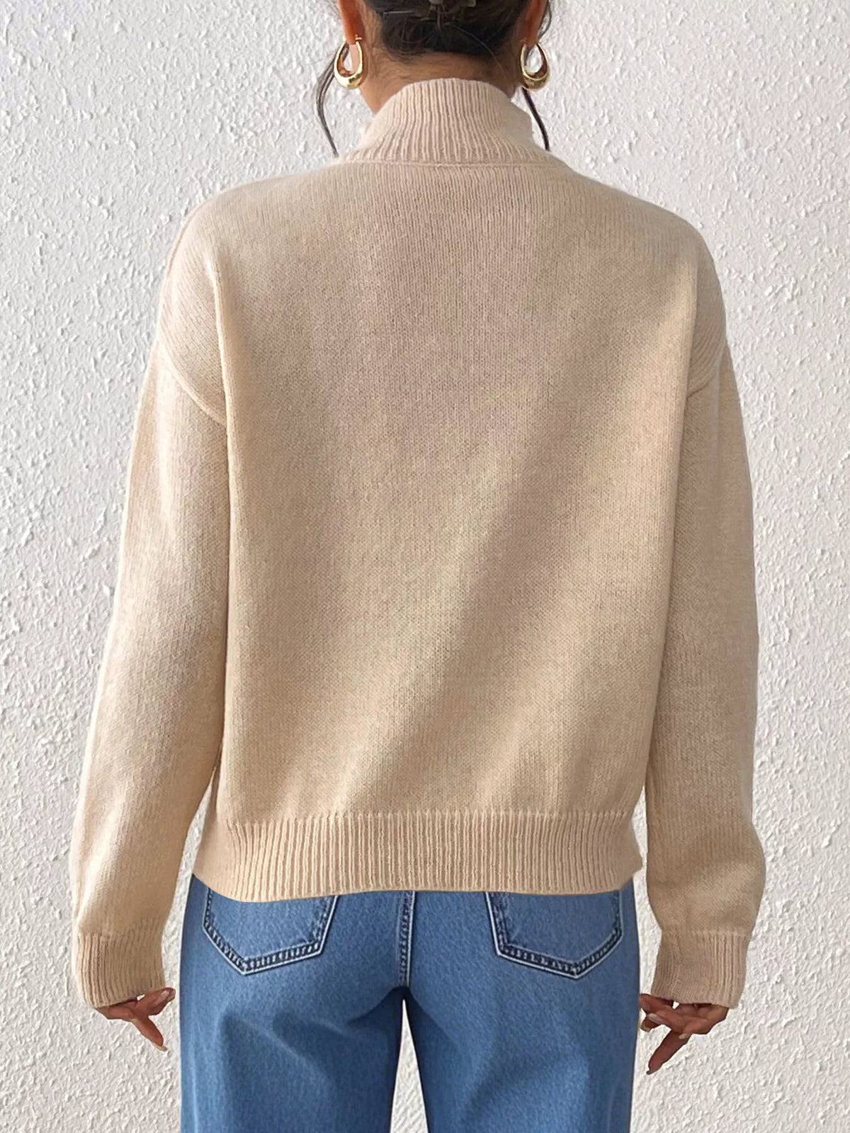Beige floral applique mock-neck sweater, back view.