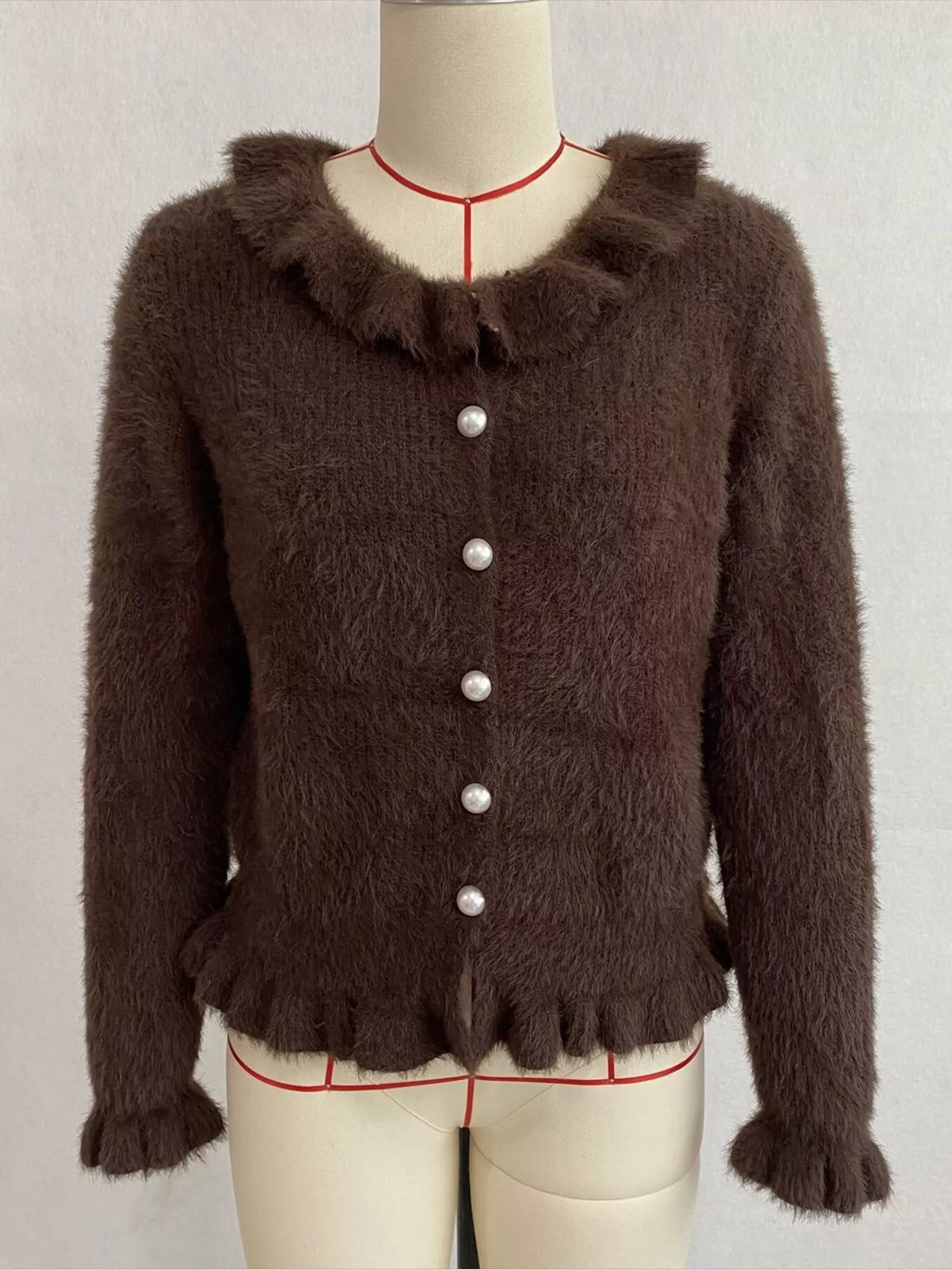 Brown fuzzy ruffle-trim button-front cardigan, front on dress form.
