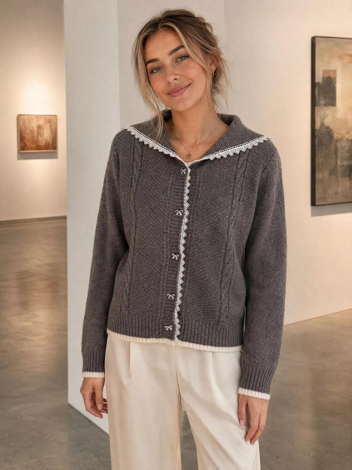 Charcoal cable-knit cardigan with lace trim, front view showing lace trim.