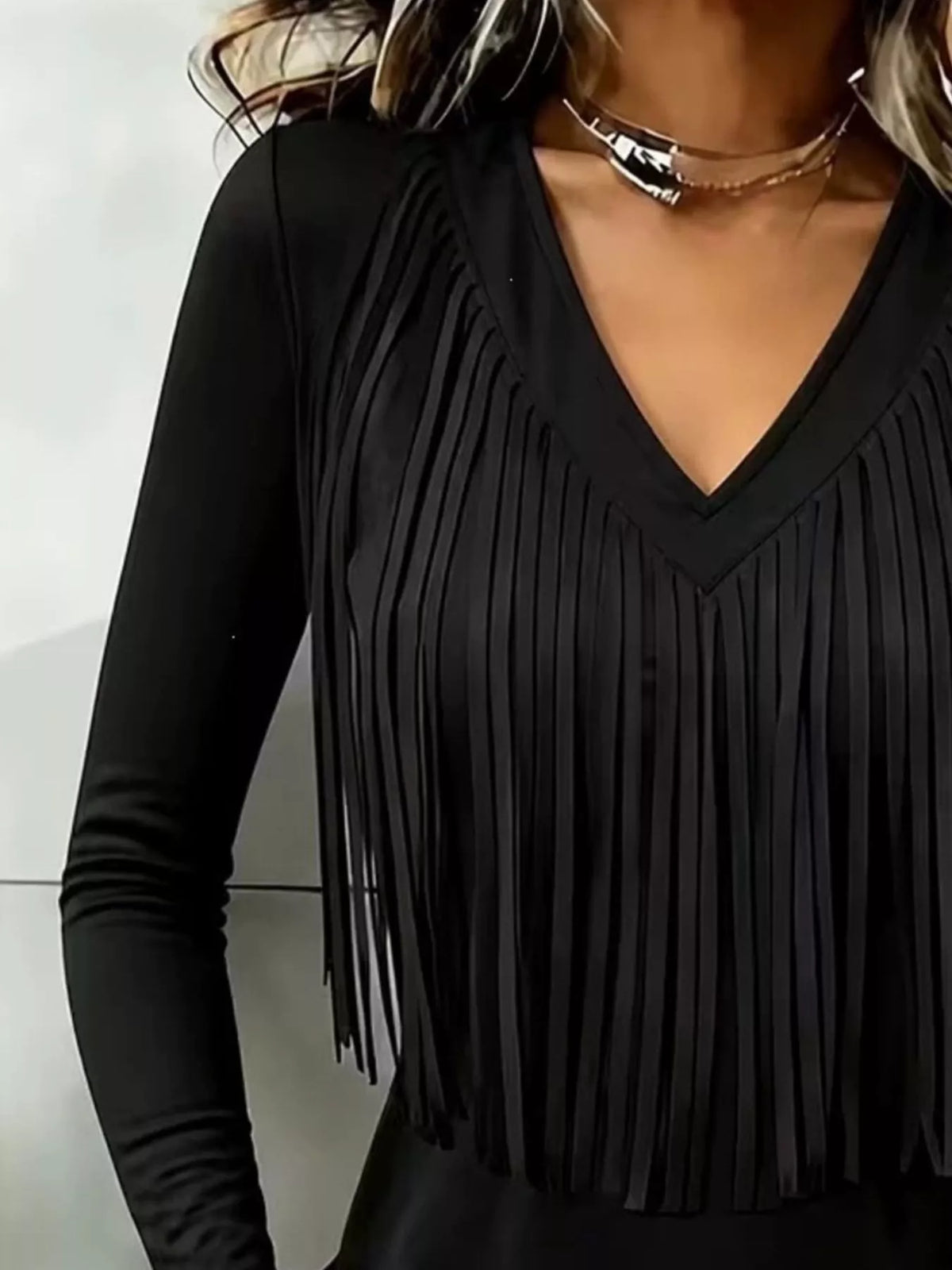 Black fringe V-neck top, neckline and fringe close-up