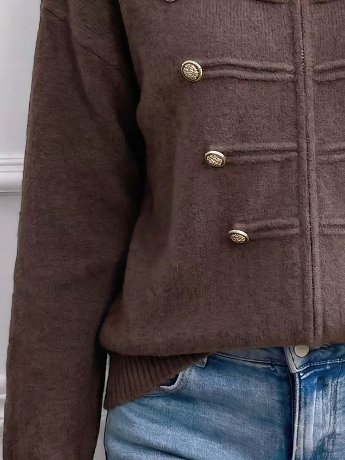 Brown zip-up long sleeve cardigan with decorative buttons, zipper and decorative button detail