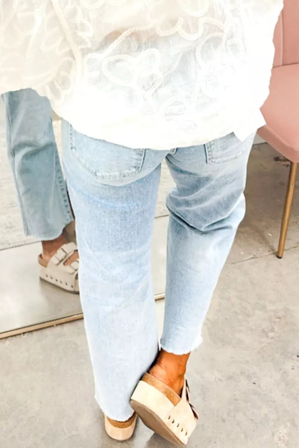 Light blue sequin turkey raw-hem ankle jeans, back view from above.