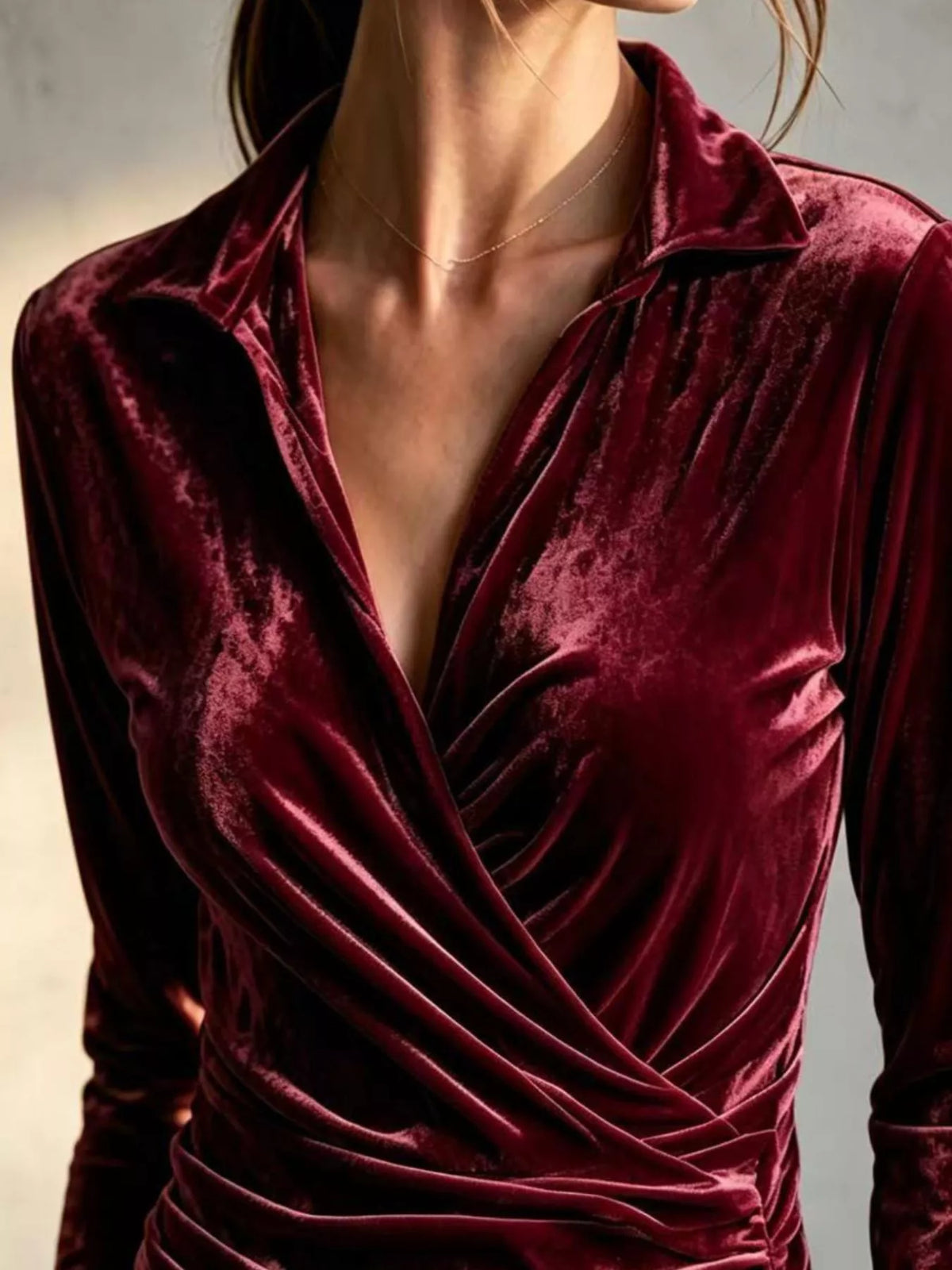Burgundy velvet wrap-front ruched blouse, wrap neckline detail.