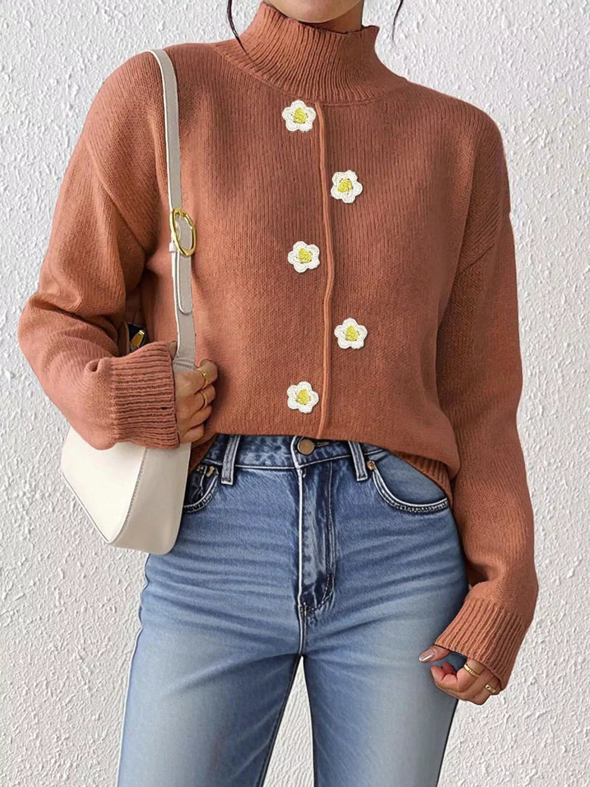Rust floral applique mock-neck sweater, front partially tucked.