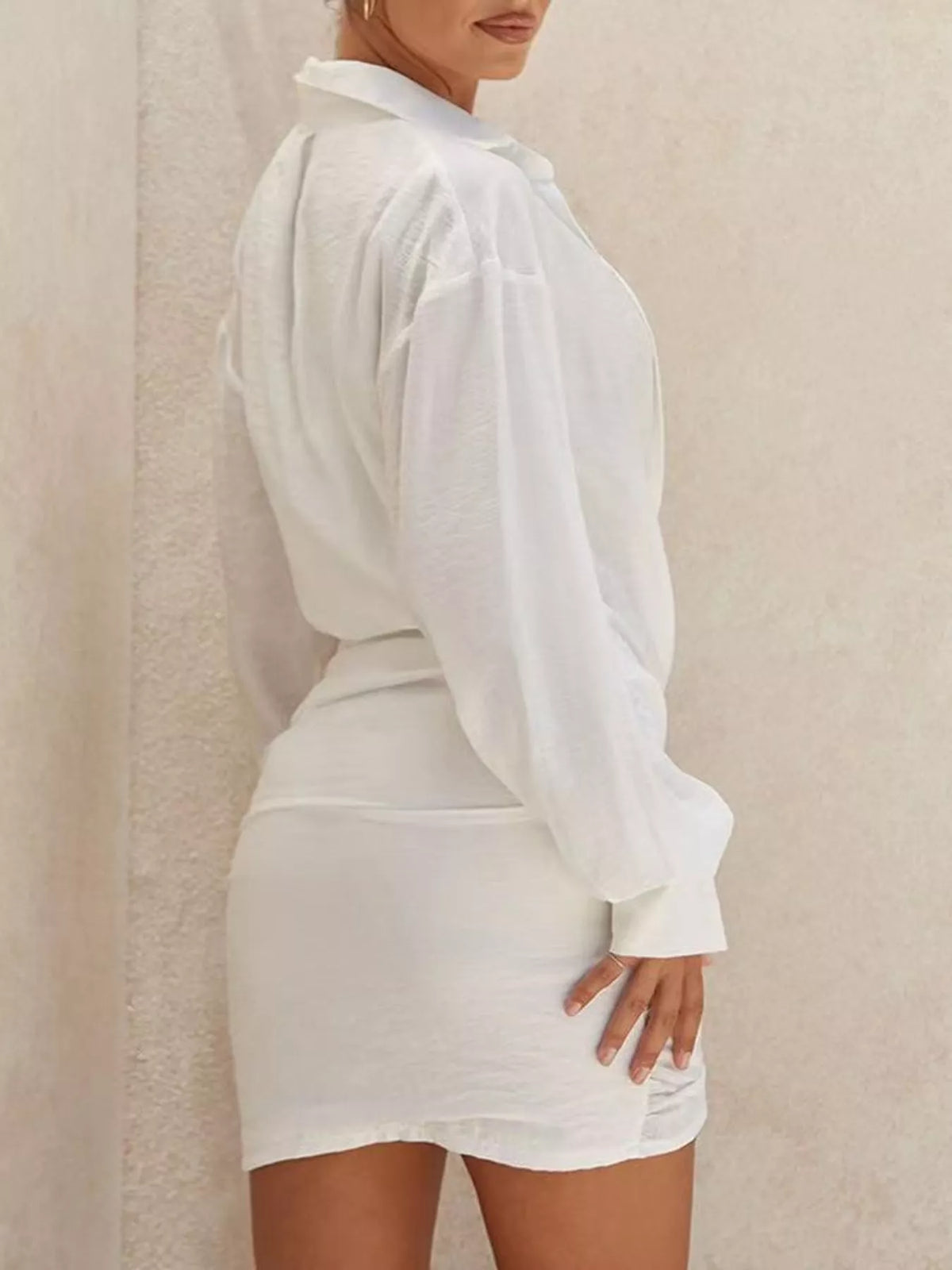 White deep v-neck ruched asymmetric mini dress, back and side view.