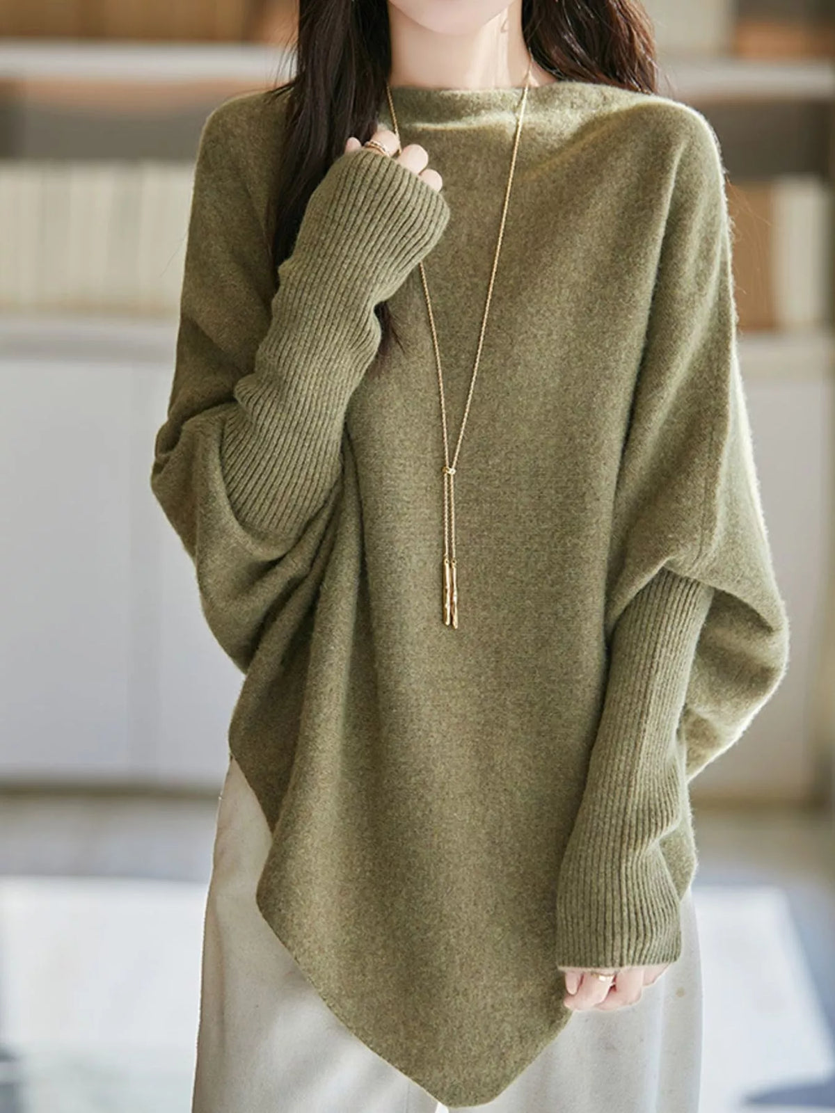 Green asymmetrical lantern sleeve sweater — front view