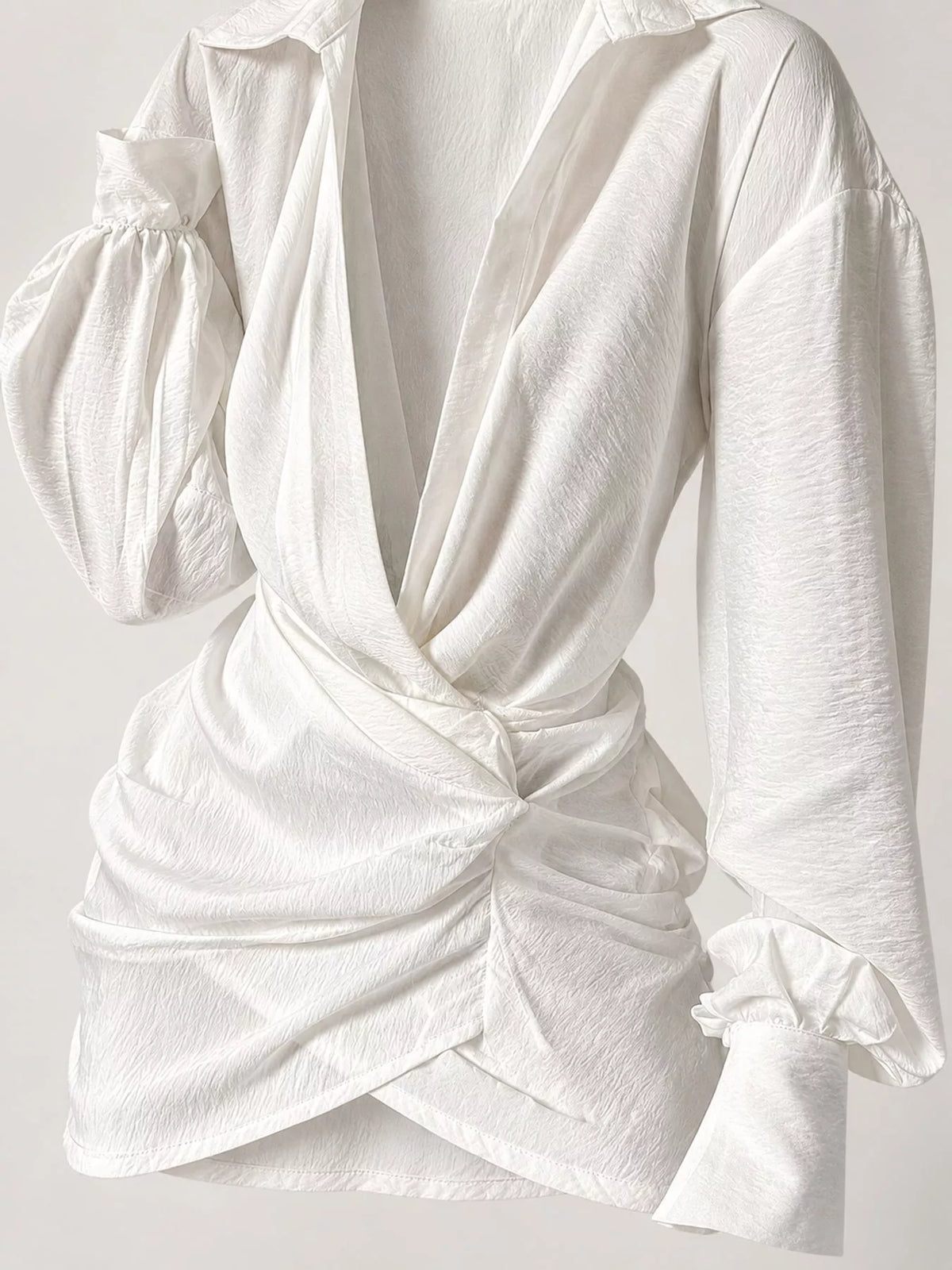 White deep v-neck ruched asymmetric mini dress, ruched waist and plunging neckline detail.
