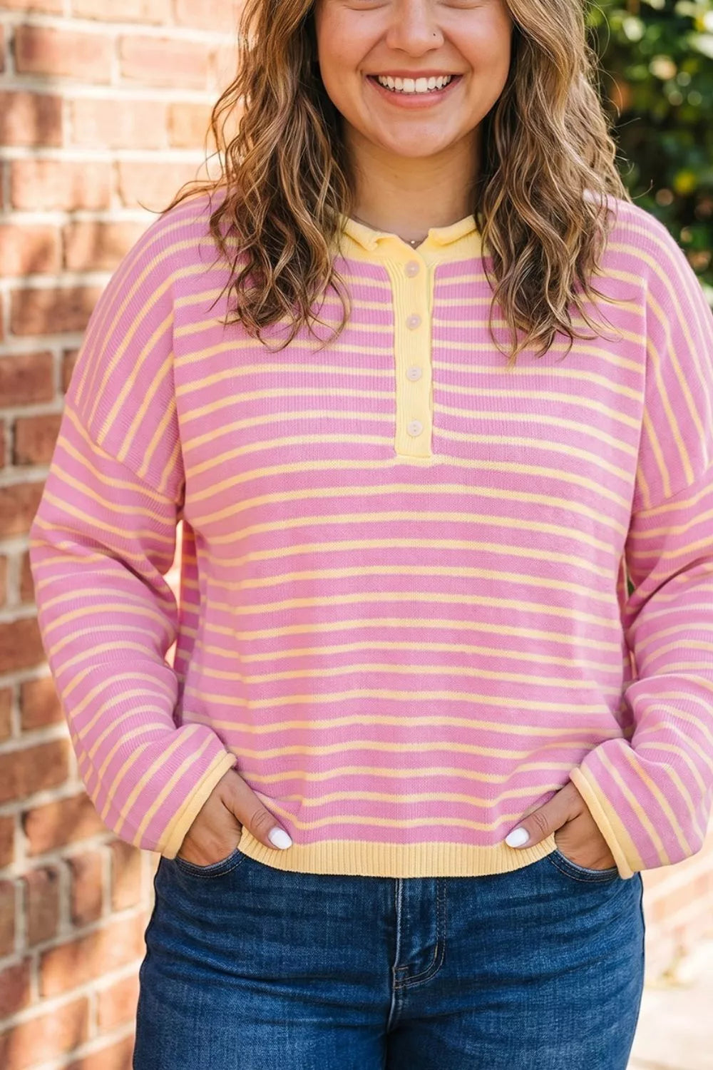 Pink and yellow striped button-detail sweater, front view