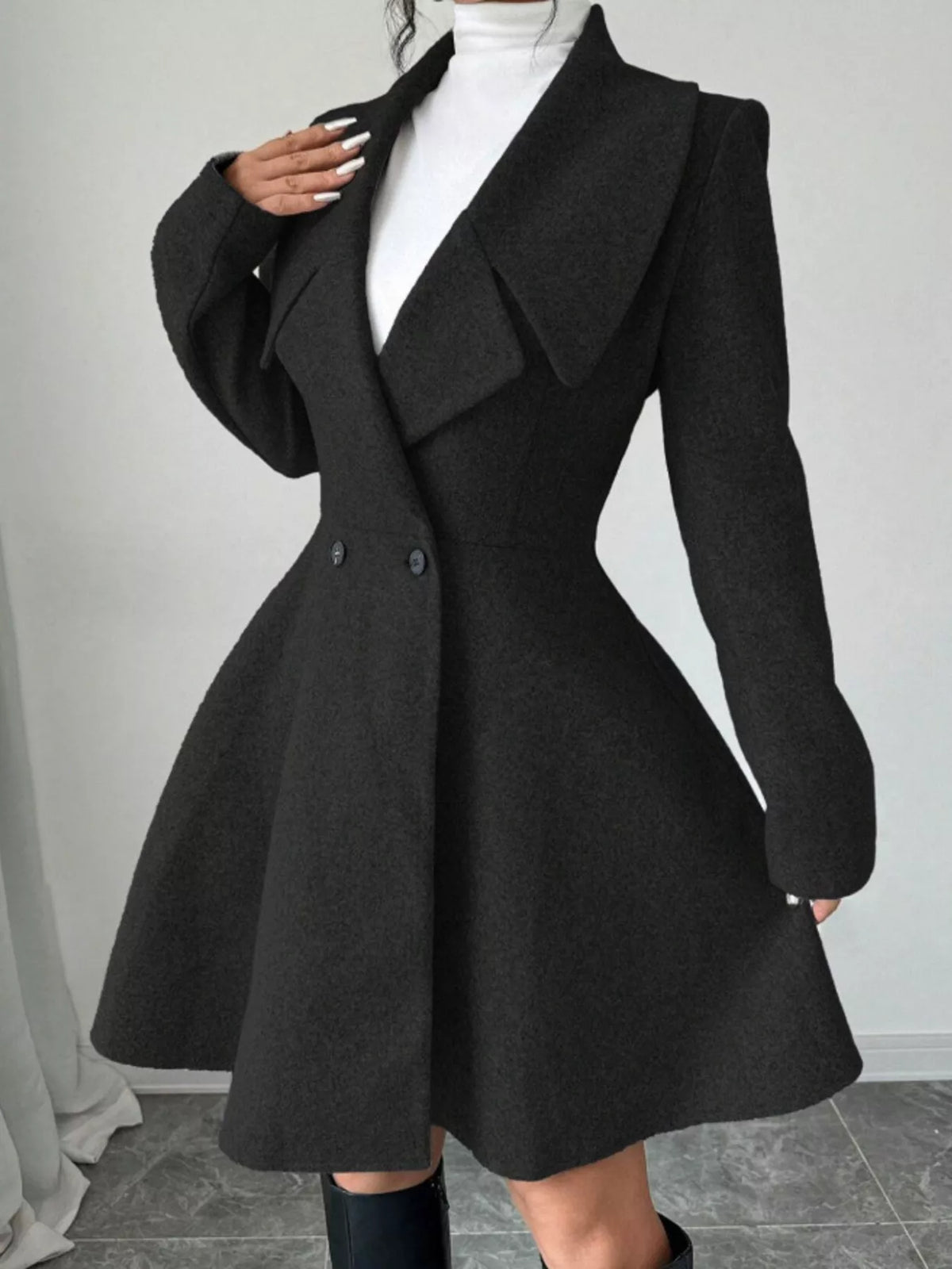 Black double-breasted flared coat, lapel and waist detail
