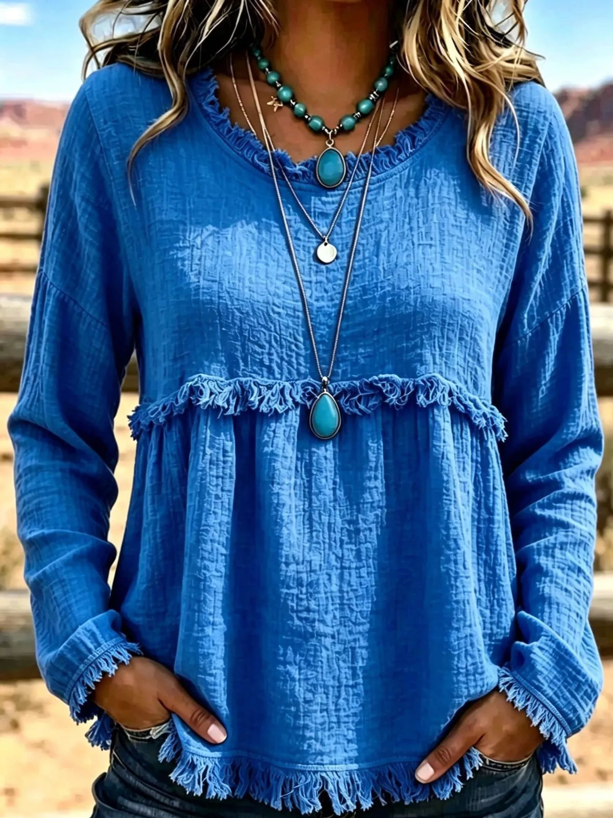 Blue frayed hem textured blouse, front view