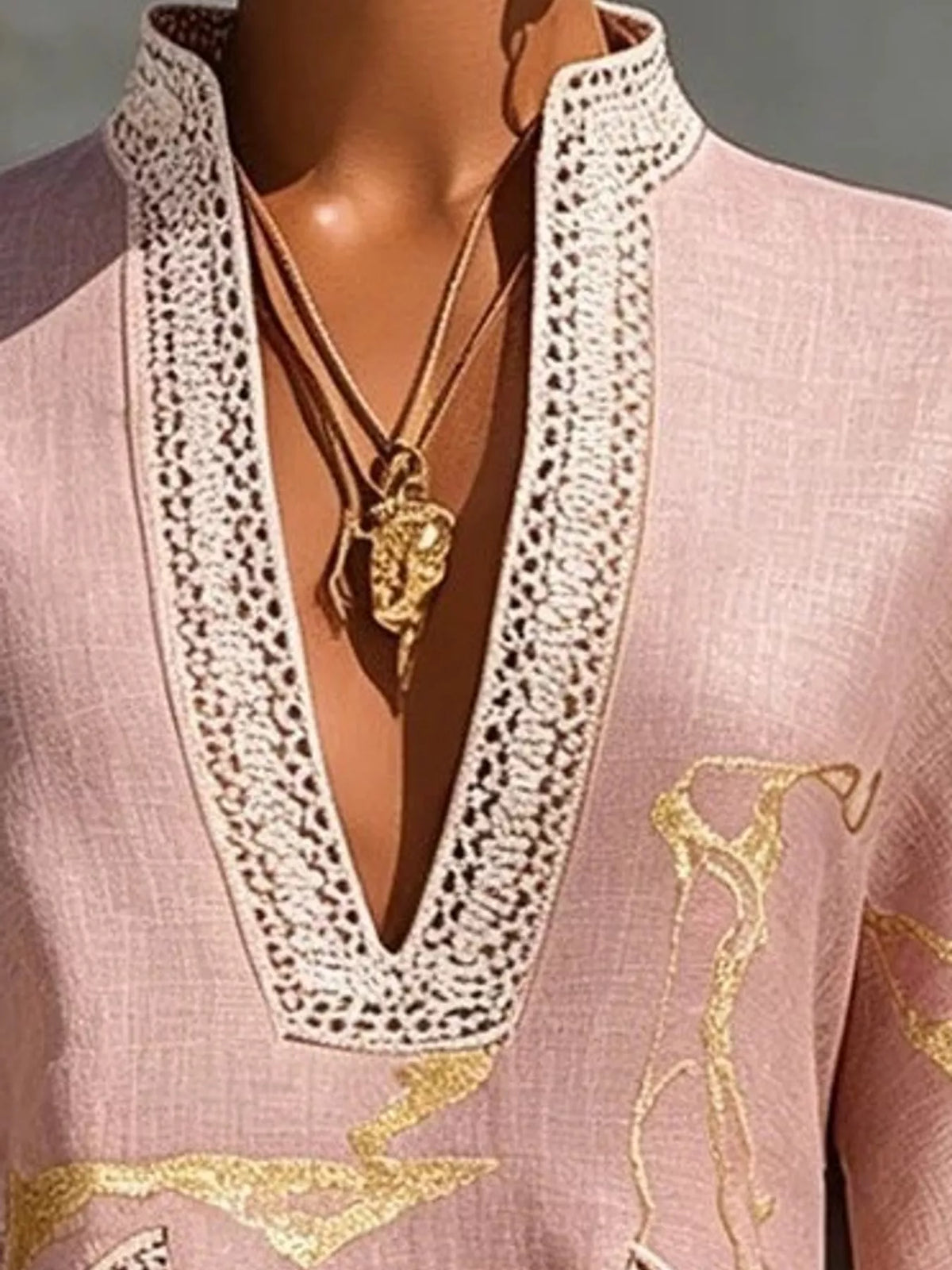 Pink notched 3/4 sleeve mini dress, close-up of the trimmed neckline