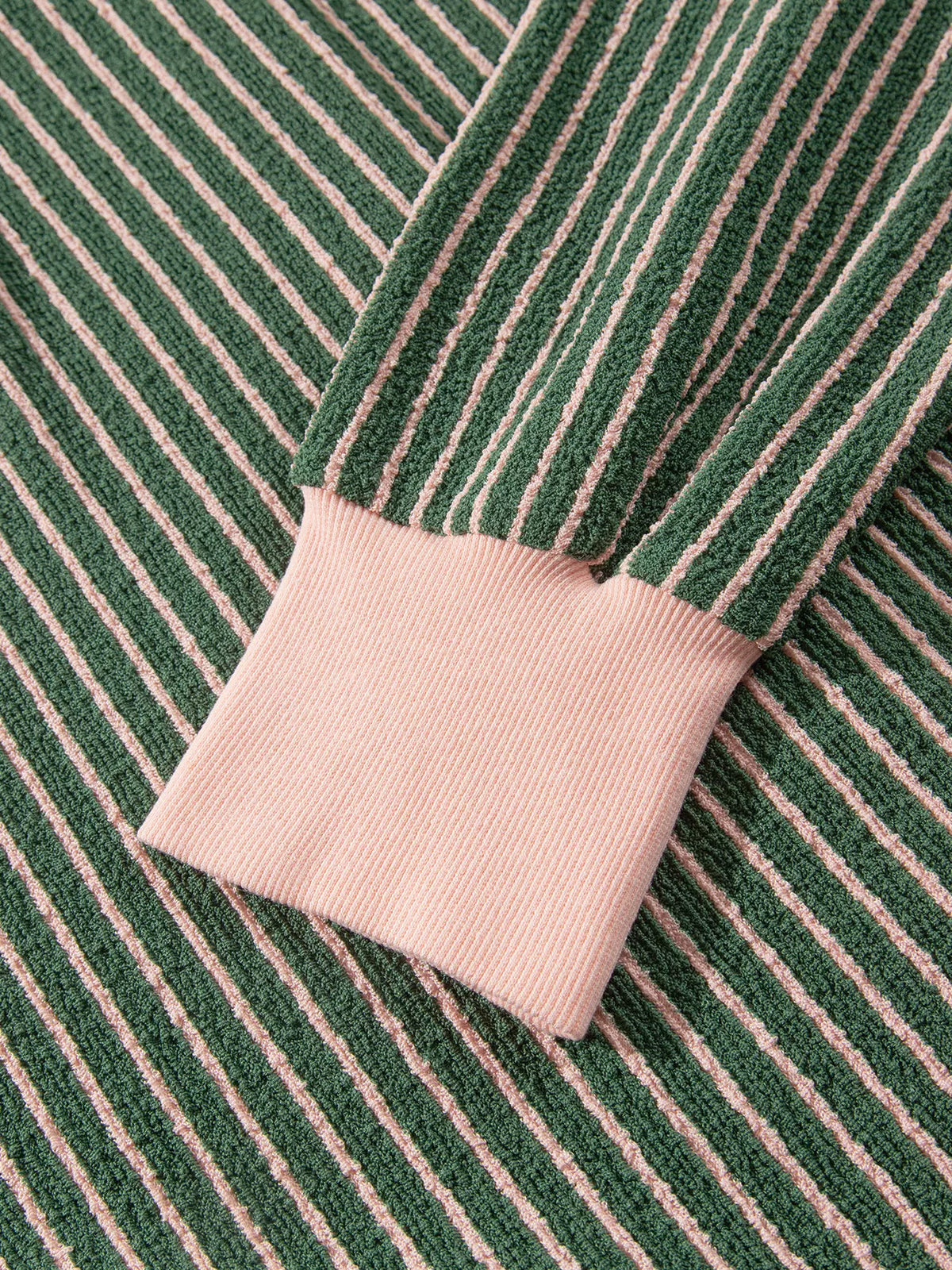 Pink sleeve cuff on green and pink striped striped round neck patchwork cardigan