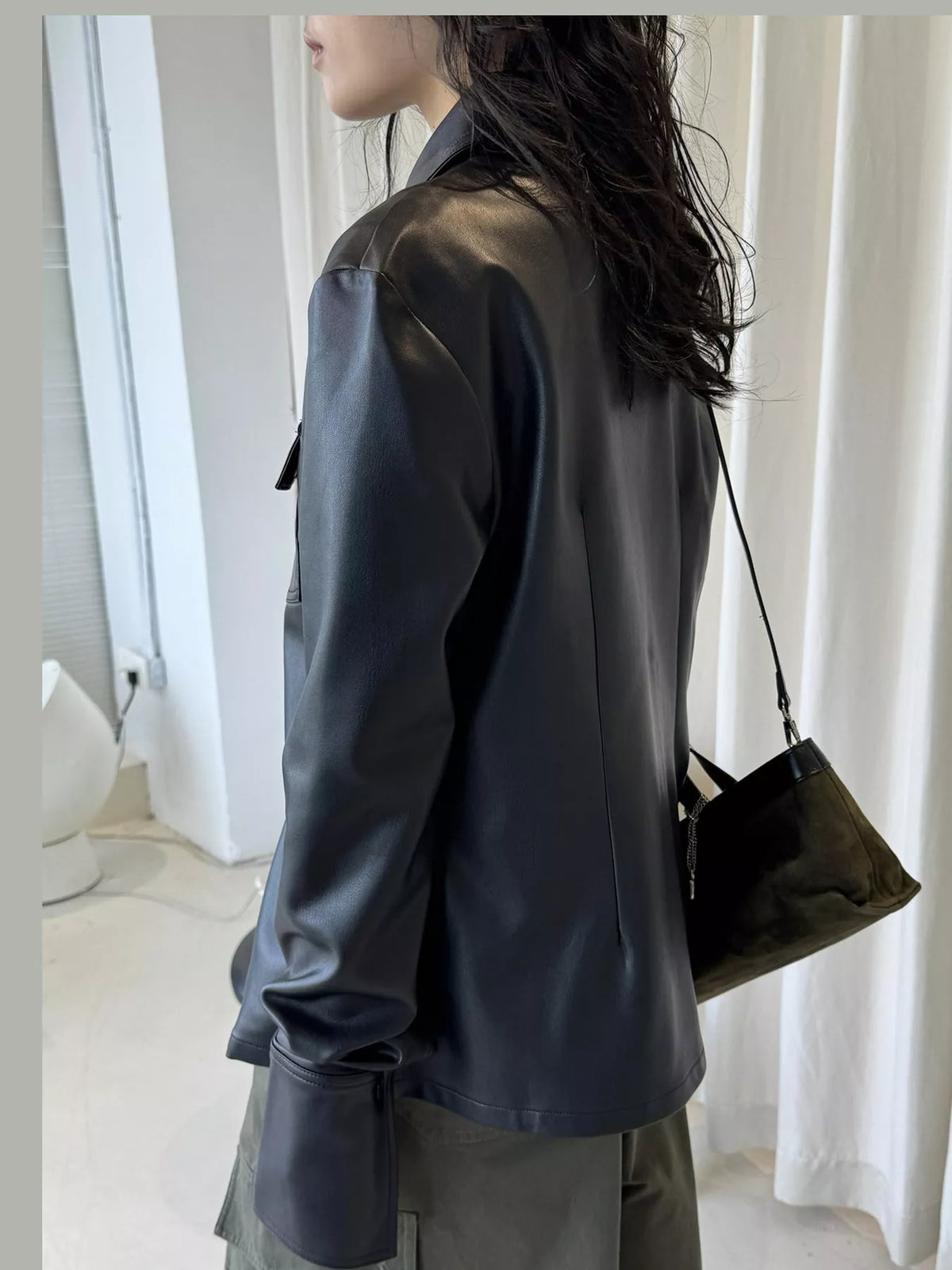 Black faux leather button-front jacket — back view