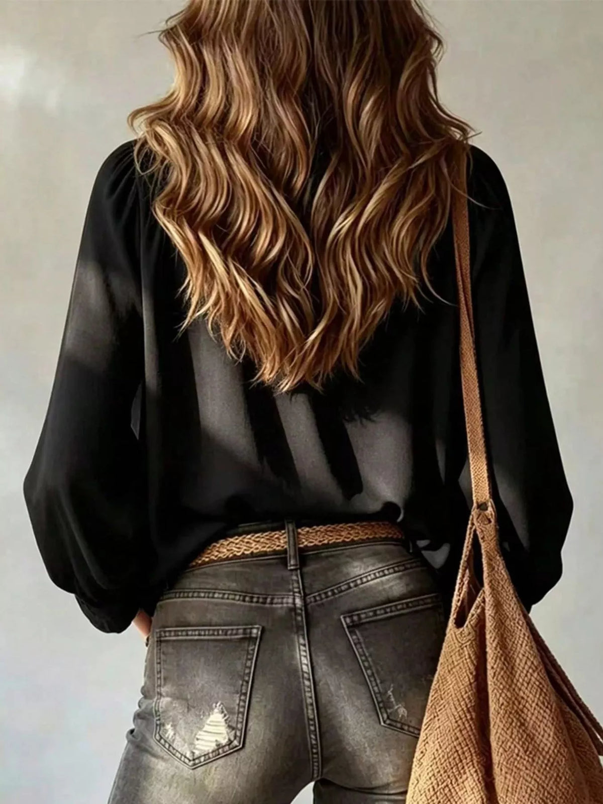 Black ruffled v-neck blouse with tie-front detail, back view