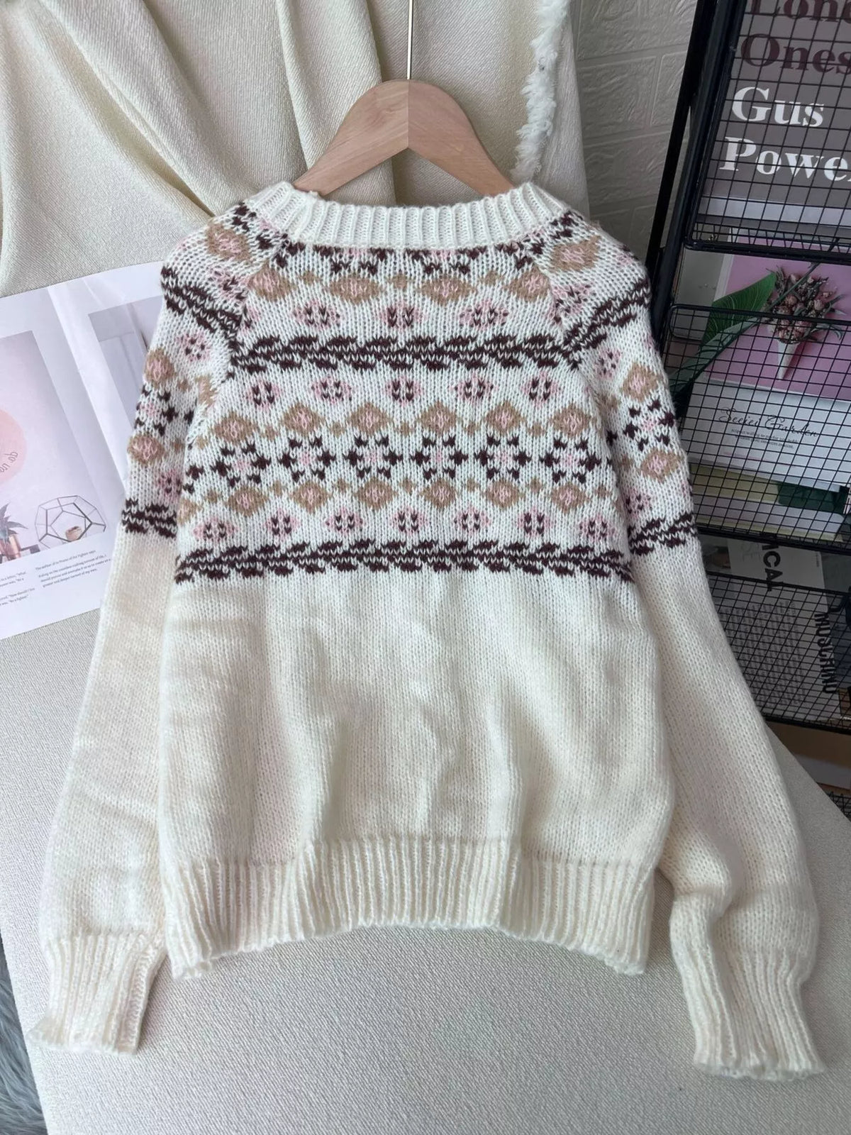 Cream fair isle round-neck sweater, back on hanger.