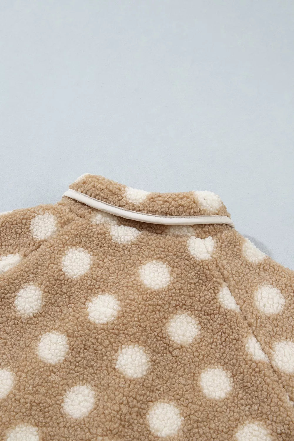Tan and white polka dot faux fur button-front jacket with zip pockets, back collar detail